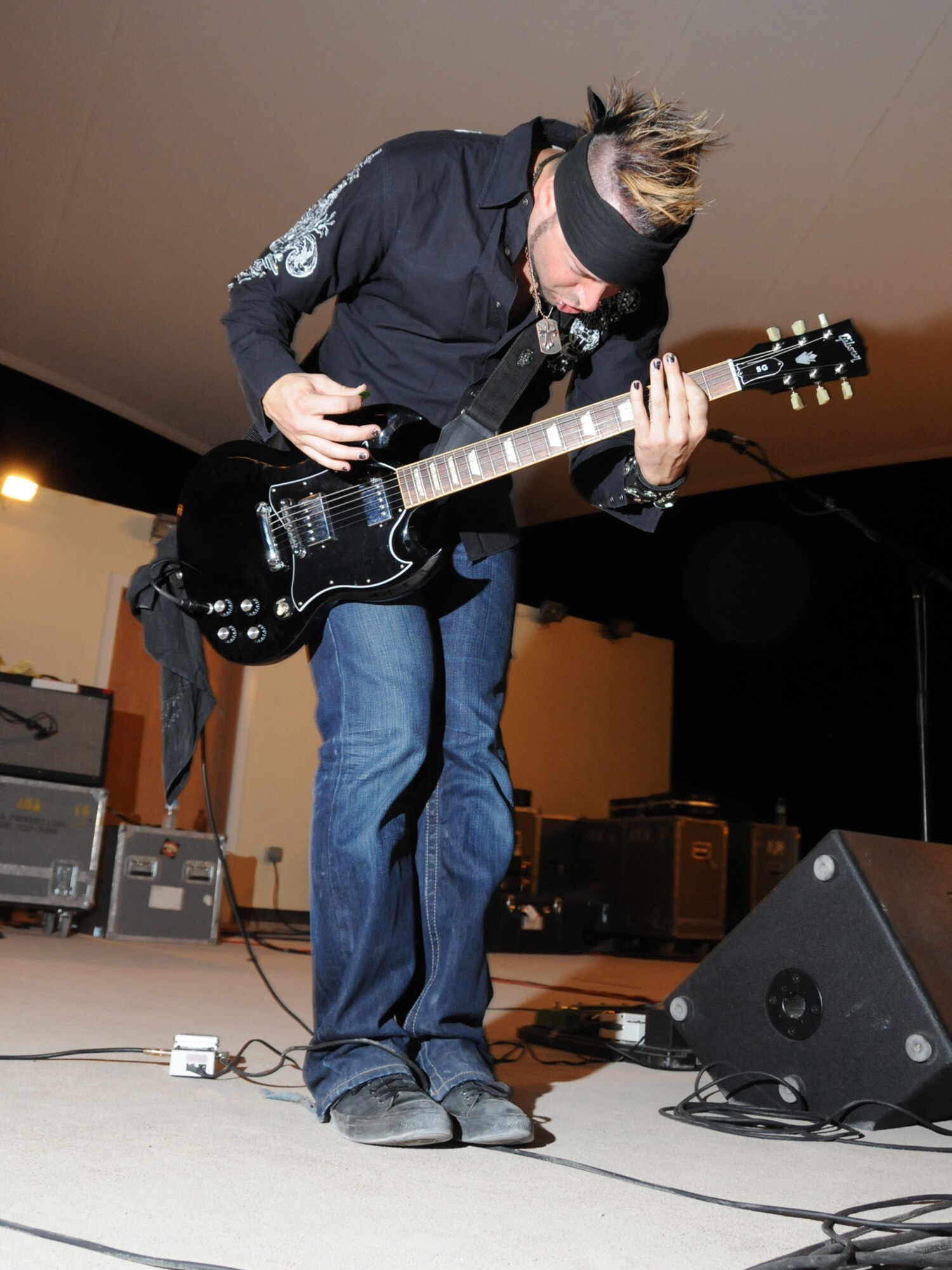 Jared, rythm guitarist for Ember, performs for a live audience of deployed service members, here, Sept. 22. Ember is an Austin, Texas-based band performing in Southwest Asia as part of an Armed Forces Entertainment-sponsored tour. (U.S. Air Force Photo/Tech. Sgt. Jason W. Edwards)  