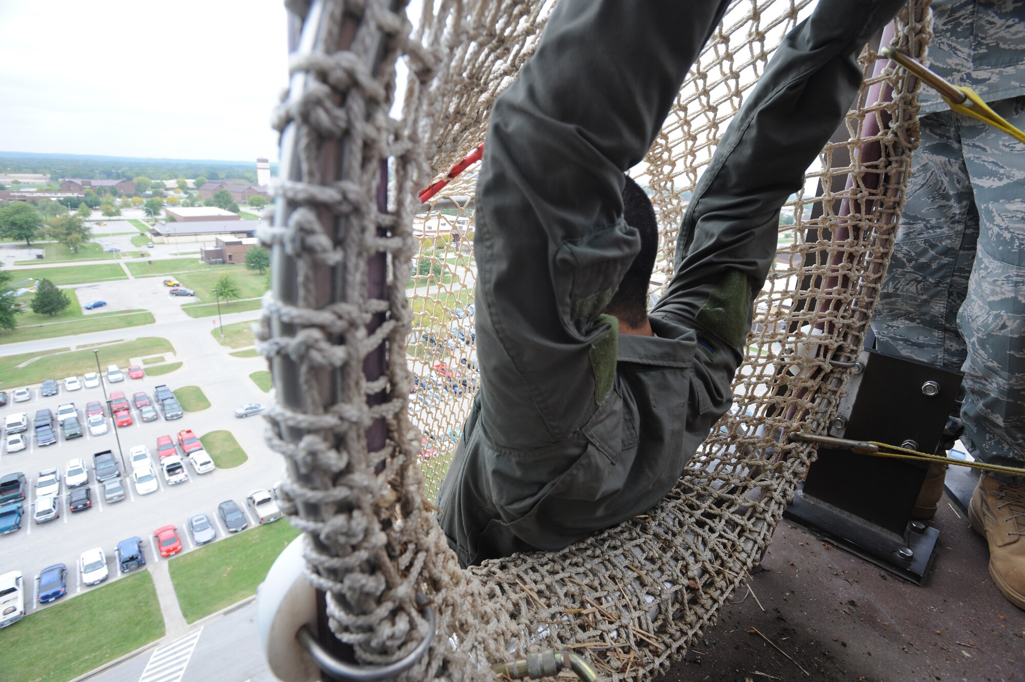 WHITEMAN AIR FORCE BASE, Mo. - Airman  First Class Christopher Palacio , 509th Operations Support Squadron ,hangs from side of tower down the fire escape tunnel preparing to release and descend, 133 feet down,  Sept. 22. Anyone who works in the tower must complete the training to ensure they know what to expect in the descent of the extreme drop. (U.S. Air Force photo/Airman 1st Carlin Leslie)