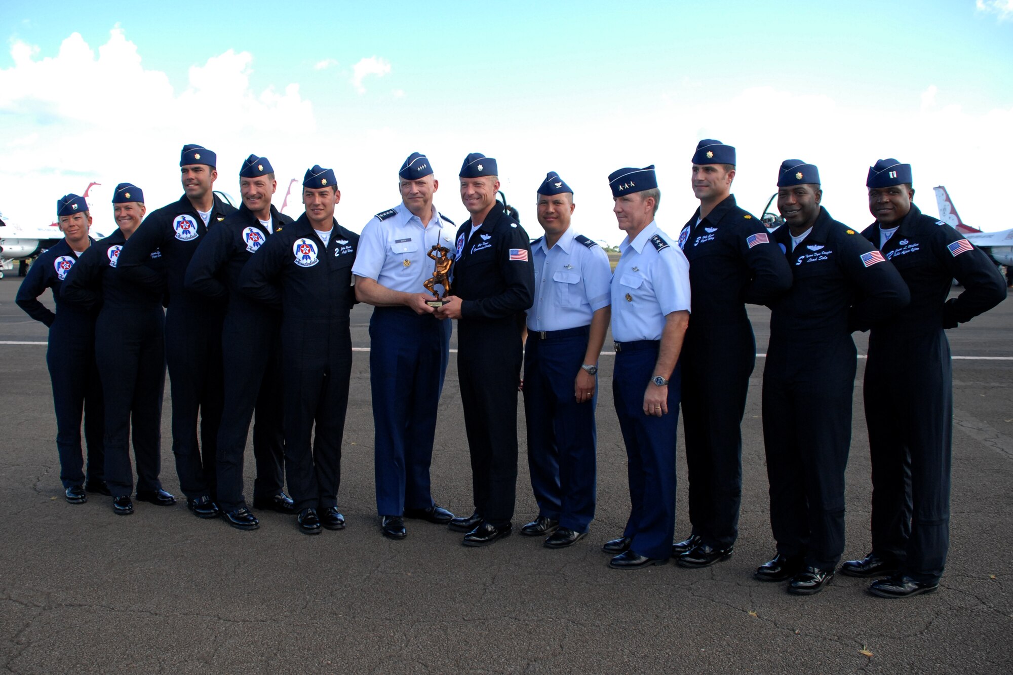 HICKAM AIR FORCE BASE, Hawaii -- Gen. Gary North, Commander, Pacific Air Forces, presents a Kekoa statue as a token of thanks for their support to Hickam?s 2009 ?Wings Over the Pacific? Open House. The Thunderbirds demonstrate the capabilities the F-16 Fighting Falcon by performing combat maneuvers during their aerial demonstration. This is Hickam's first open house since 2003, and a crowd of nearly 100,000 paid a visit during the weekend. (U.S. Air Force photo/Staff Sgt. Mike Meares)