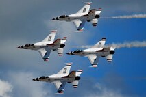 HICKAM AIR FORCE BASE, Hawaii -- The Thunderbirds, U.S. Air Force Demonstration Squadron, perform over Hickam Air Force Base, Hawaii, during the "Wings Over the Pacific," Open House Sept. 20 before a crowd of more than 57,000. The Thunderbirds demonstrate the capabilities the F-16 Fighting Falcon by performing combat maneuvers during their aerial demonstration. This is Hickam's first open house since 2003, and a crowd of nearly 100,000 paid a visit during the weekend. (U.S. Air Force photo/Staff Sgt. Mike Meares)