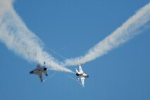 HICKAM AIR FORCE BASE, Hawaii -- The Thunderbirds, U.S. Air Force Demonstration Squadron, perform over Hickam Air Force Base, Hawaii, during the "Wings Over the Pacific," Open House Sept. 20 before a crowd of more than 57,000. The Thunderbirds demonstrate the capabilities the F-16 Fighting Falcon by performing combat maneuvers during their aerial demonstration. This is Hickam's first open house since 2003, and a crowd of nearly 100,000 paid a visit during the weekend. (U.S. Air Force photo/Staff Sgt. Mike Meares)