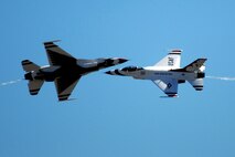 HICKAM AIR FORCE BASE, Hawaii -- The Thunderbirds, U.S. Air Force Demonstration Squadron, perform over Hickam Air Force Base, Hawaii, during the "Wings Over the Pacific," Open House Sept. 20 before a crowd of more than 57,000. The Thunderbirds demonstrate the capabilities the F-16 Fighting Falcon by performing combat maneuvers during their aerial demonstration. This is Hickam's first open house since 2003, and a crowd of nearly 100,000 paid a visit during the weekend. (U.S. Air Force photo/Staff Sgt. Mike Meares)