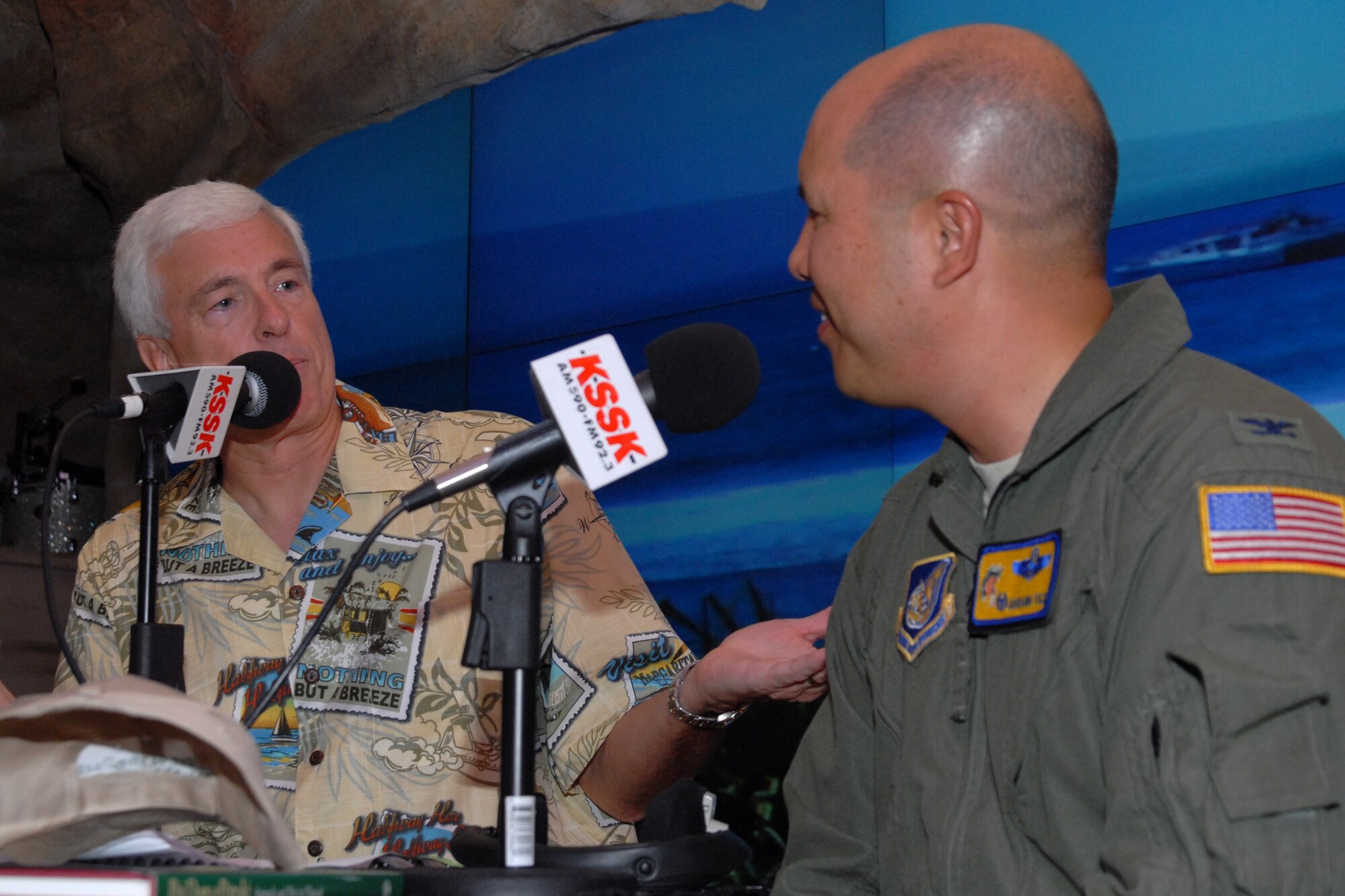 WAIKIKI, Hawaii -- Col. Giovanni Tuck, 15th Airlift commander, speaks with Michael Perry during a live broadcast of the Perry and Price Show at Jimmy Buffet?s restaurant at the Ohana Waikiki Beachcomber Hotel Sept. 19. Colonel Tuck answered questions about Hickam Air Force Base?s Open House, ?Wings Over the Pacific.? The Thunderbirds, U.S. Air Force Demonstration Squadron, were the headliners during the open house. They demonstrate the capabilities the F-16 Fighting Falcon by performing combat maneuvers during their aerial demonstration. This is Hickam's first open house since 2003, and a crowd of nearly 100,000 paid a visit during the weekend. (U.S. Air Force photo/Staff Sgt. Mike Meares)