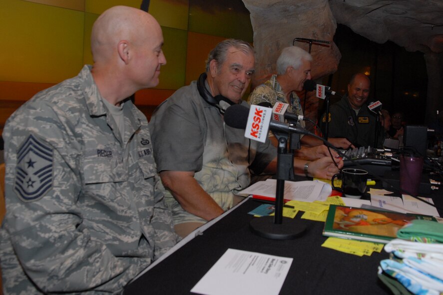 WAIKIKI, Hawaii -- Col. Giovanni Tuck, 15th Airlift commander, and Chief Master Sgt. Craig Recker, 15th AW command chief master sergeant, speaks with Michael Perry and Larry Price during a live broadcast of the Perry and Price Show at Jimmy Buffet?s restaurant at the Ohana Waikiki Beachcomber Hotel Sept. 19. Colonel Tuck and Chief Recker spoke about Hickam Air Force Base?s Open House, ?Wings Over the Pacific.? The Thunderbirds, U.S. Air Force Demonstration Squadron, were the headliners during the open house. They demonstrate the capabilities the F-16 Fighting Falcon by performing combat maneuvers during their aerial demonstration. This is Hickam's first open house since 2003, and a crowd of nearly 100,000 paid a visit during the weekend. (U.S. Air Force photo/Staff Sgt. Mike Meares)