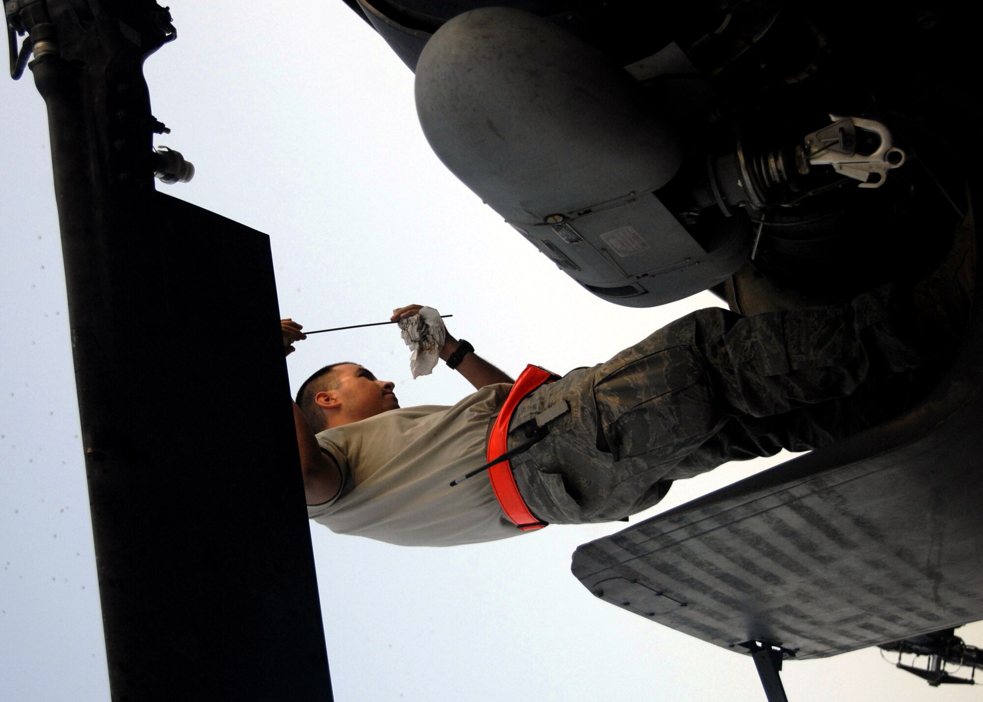 KANDAHAR AIRFIELD, Afghanistan -- Senior Airman Shane Garza checks the oil of an HH-60 Pave Hawk during a pre-flight inspection here, Sept. 21, 2009. Pre-flight inspections consist of everything from checking for stress fractures to fluids, tires, guns, propellers and controls just to qualify for flight. Airman Garza is a crew cheif with the 55th Expeditionary Helicopter Maintenance Unit from Davis-Monthan Air Force Base, Ariz. and hails from Grapevine, Texas. (U.S. Air Force photo/Senior Airman Timothy Taylor)