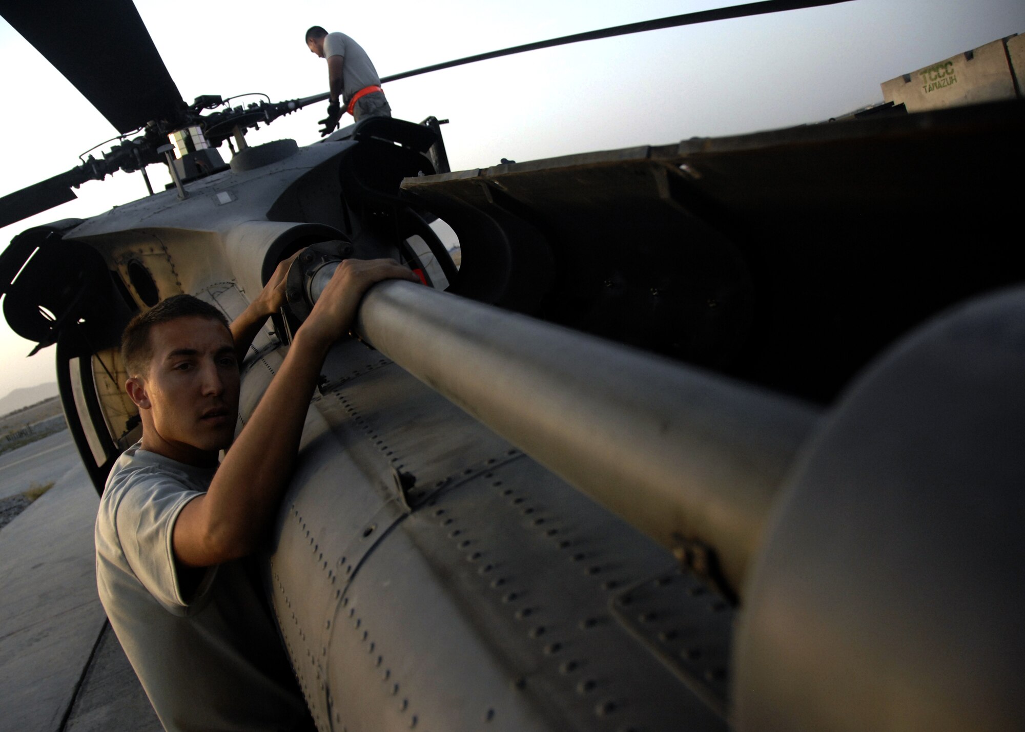KANDAHAR AIRFIELD, Afghanistan -- Senior Airman Joshua Marcantel inspects the driveshaft to the rear blades of an HH-60 Pave Hawk during a pre-flight inspection here, Sept. 21, 2009. Pre-flight inspections consist of everything from checking for stress fractures to fluids, tires, guns, propellers and controls just to qualify for flight. Airman Marcantel is an HH-60 crew chief with the 55th Expeditionary Helicopter Maintenance Unit from Davis-Monthan Air Force Base, Tucson, Ariz. and hails from Elkins, W.V. (U.S. Air Force photo/Senior Airman Timothy Taylor)