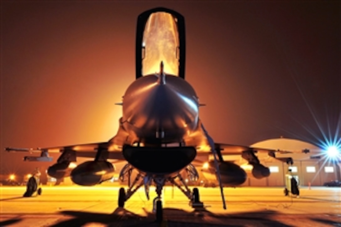 An F-16 fighter jet stands ready for departure early in the morning on Truax Field in Madison, Wis., Sept. 22, 2009. The 115th Fighter Wing of the Wisconsin Air National Guard launched 14 F-16s as part of its scheduled Aerospace Expeditionary Force rotation that began recently when about 200 of the unit's members deployed.