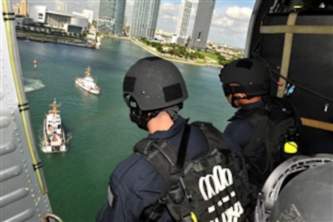 U.S. Coast Guard Maritime Safety and Security Team 91114 personnel overlook the Coast Guard Cutters Diamondback and Gannet near downtown Miami, Sept. 17, 2009. The Maritime Safety and Security Team crewmembers conducted a vertical insertion demonstration for members of the Joint Civilian Orientation Conference who were watching from the cutters.
