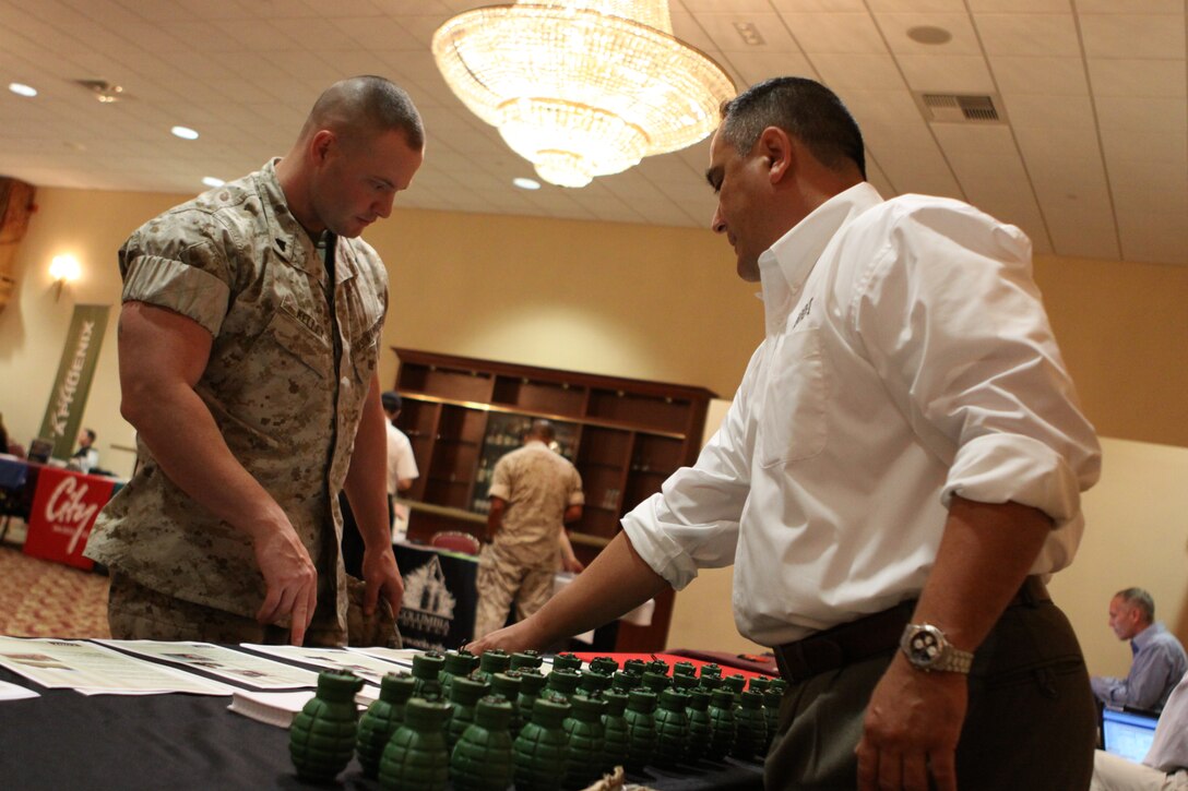 Cpl. Brandon C. Kelley, a corrections specialist with Security Battalion, Marine Corps Base Camp Pendleton, asks Tony Morocco about the career opportunities at EOD Technology, Inc. The 22nd Annual Fall Career and Education expo attracted about 2,500 Marines, sailors and family members to the South Mesa Club, Sept. 25.