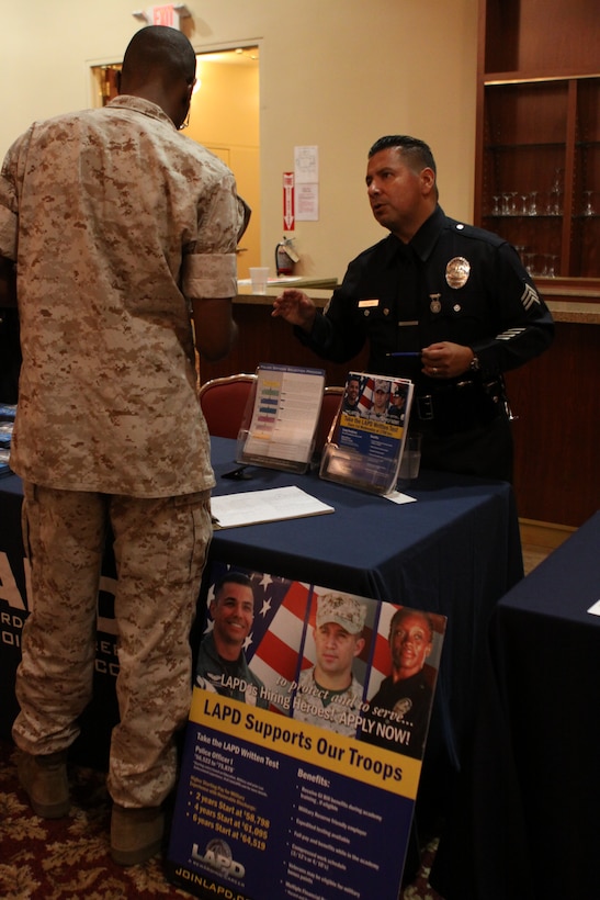 Police Sgt. Guillermo Galvan, Los Angeles Police Department, speaks to Sgt. Bryan L. Moore, motor vehicle operator, 1st Supply Battalion, Combat Logistics Regiment 15, 1st Marine Logistics Group, during the 22nd Annual Fall Career and Education Expo, Sept. 25.
