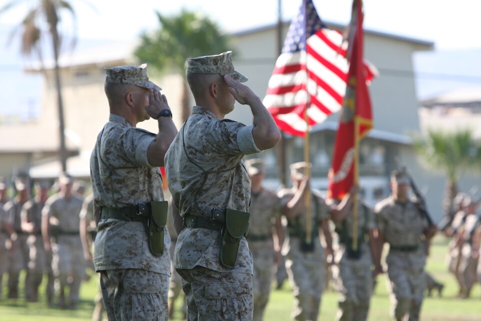Lt. Cols. Scott G. Fosdal (left) and Todd P. SImmons, the outgoing and incoming 1st Battalion, 7th Marine Regiment, commanding officers respectively, salute Marines during the Pass and Review portion of the 1/7 change of command ceremony at Lance Cpl. Torrey L. Gray Field Sept. 25.