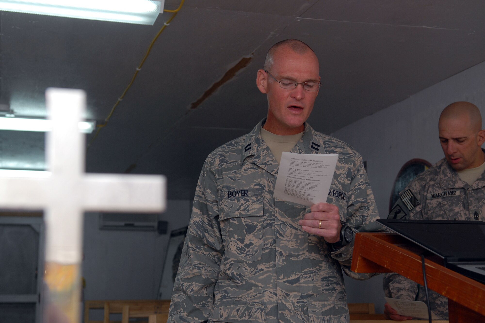 FORWARD OPERATING BASE WRIGHT, Afghanistan -- U.S. Air Force Chaplain (Capt.) Eric Boyer (center) leads a non-denominational service for deployed members at Camp Wright, Afghanistan, Sept. 21, 2009.  This service is one of several ministry opportunities that Chaplain Boyer participates in and offers to all military members who are stationed at or pass through the forward operating base.  The chaplain is deployed from the 12th Flying Training Wing at Randolph Air Force Base, Texas, and a native of Knoxville, Tenn. He is assigned to the Combined Joint Task Force-82 chaplain corps and was sent forward to Camp Wright.  (U.S. Air Force photo/Tech. Sgt. Brian Boisvert)
