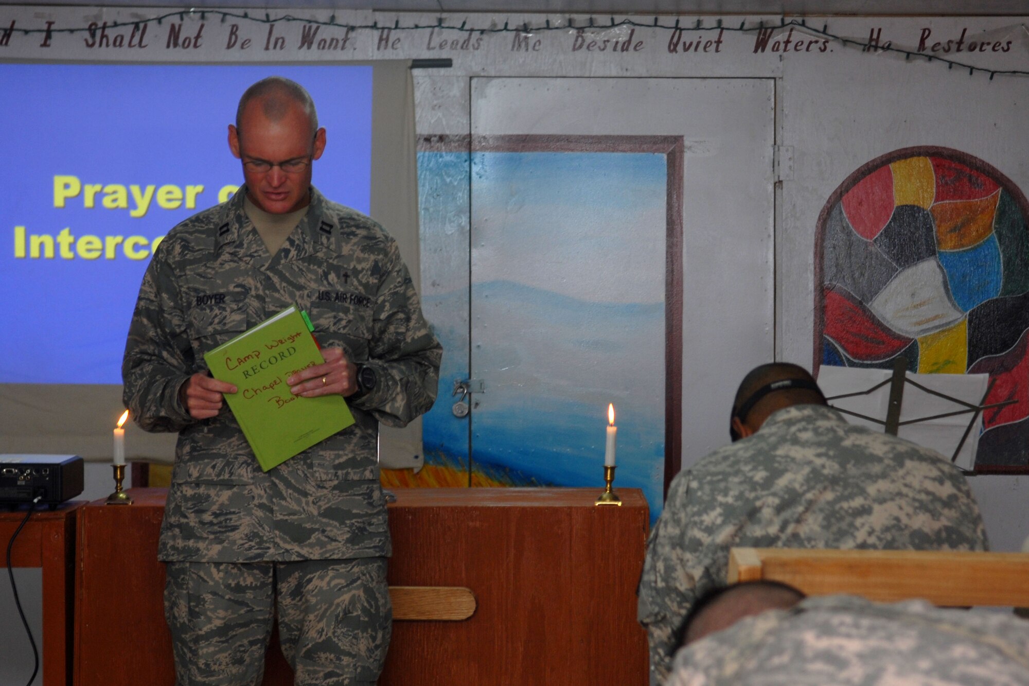 FORWARD OPERATING BASE WRIGHT, Afghanistan -- U.S. Air Force Chaplain (Capt.) Eric Boyer (left) leads a non-denominational service for deployed members at Camp Wright, Afghanistan, Sept. 21, 2009.  This service is one of several ministry opportunities that Chaplain Boyer participates in and offers to all military members who are stationed at or pass through the forward operating base.  The chaplain is deployed from the 12th Flying Training Wing at Randolph Air Force Base, Texas, and a native of Knoxville, Tenn. He is assigned to the Combined Joint Task Force-82 chaplain corps and was sent forward to Camp Wright.  (U.S. Air Force photo/Tech. Sgt. Brian Boisvert)