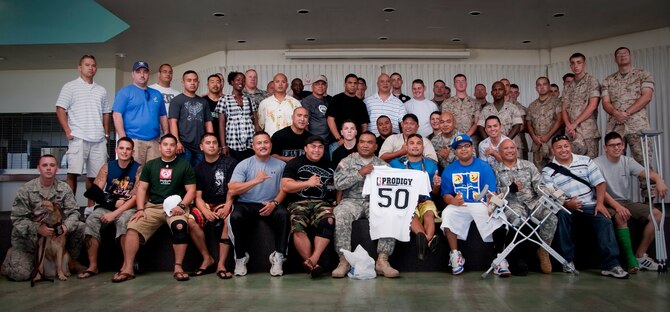 HICKAM AIR FORCE BASE, Hawaii -- Ultimate Fighting Champion, lightweight category, BJ Penn visits 50 U.S. Army and Marine Corps Wounded Warriors on the lanai here Sept. 18. Penn's two-day visit to Hickam AFB also included an orientation flight in a Thunderbirds F-16 Falcon in conjunction with the 2009 Open House. The event drew more than 99,000 people. (U.S. Marine Corps photo by Sgt. Mark A. Fayloga)