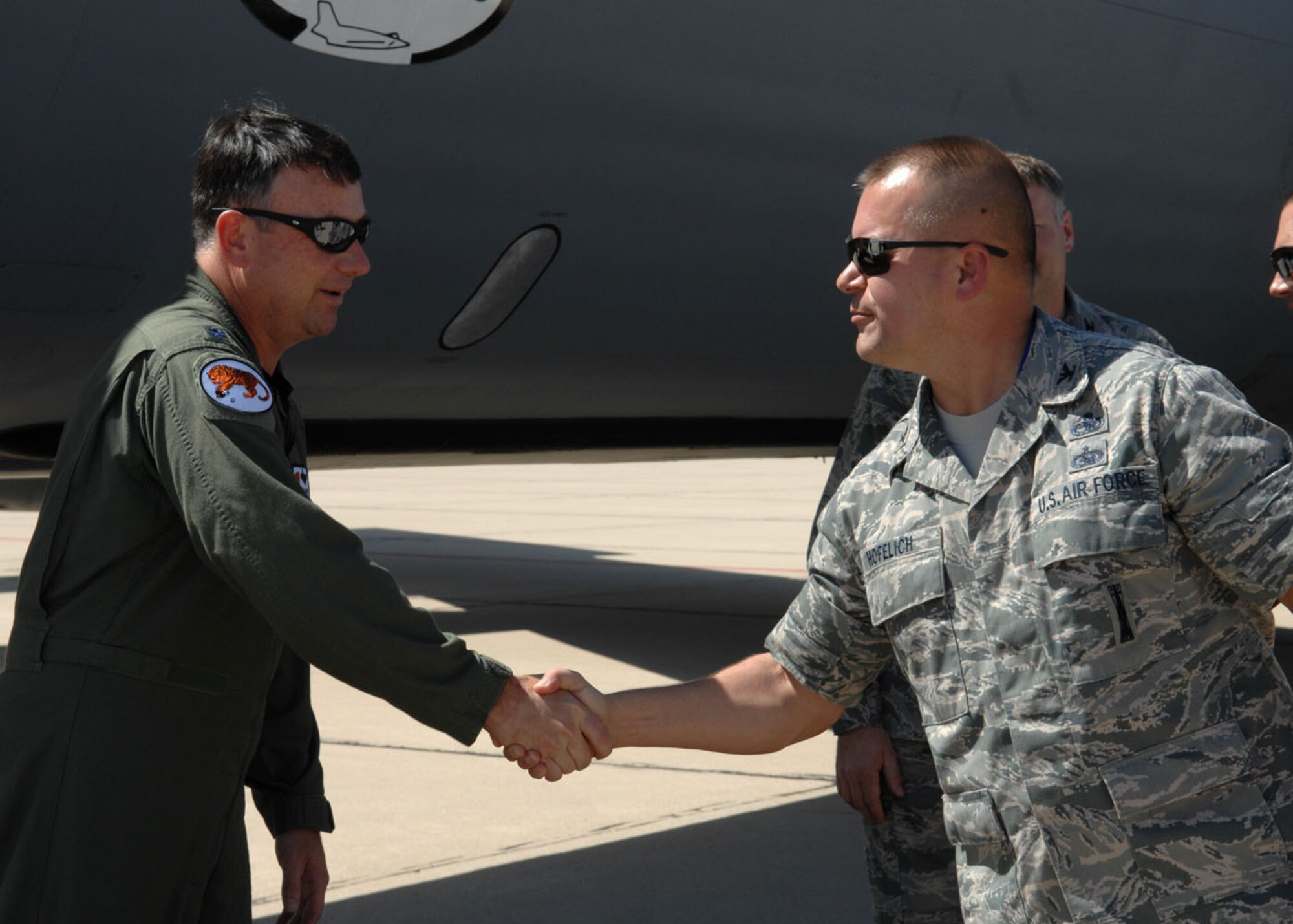 Col. Peter Hofelich, 355th Maintenance Group commander,  shakes the hand of Lt. Col. Christian Lawlor Sept. 23 after he landed the last KC-135E on Davis-Monthan, where the aircraft will retire after more than 50 years of active service. (U.S. Air Force photo by Airman Jerilyn Quintanilla)