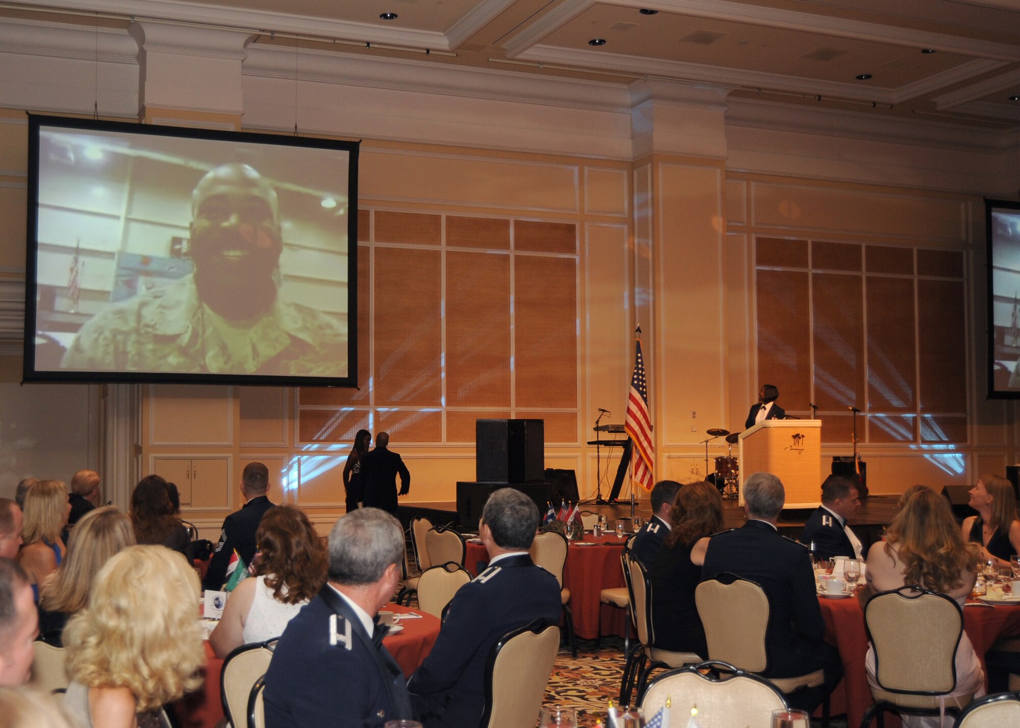 LAS VEGAS -- Attendees of the 2009 Nellis-Creech Air Force Ball, dedicated to deployed Airmen, enjoyed a special greeting from Tech. Sgt. Mark Lance, a Nellis liquid technician deployed to the 332nd Expeditionary Civil Engineer Squadron from Joint Base Balad, Iraq. The greeting was live from Iraq and through a video-conference. (U. S. Air Force photo by Airman 1st Class Stephanie Rubi)
