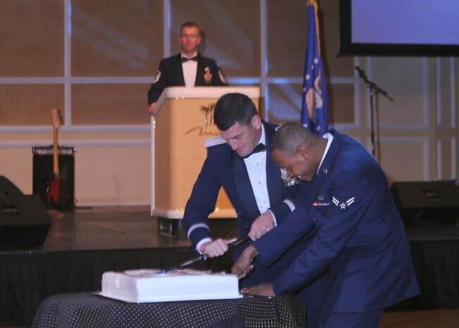 LAS VEGAS -- Brig. Gen. Russell Handy, 57th Wing commander, and Airman 1st Class Justin Peoples, an airfield management journeyman from the 18th Reconnaissance Squadron, cut a birthday cake celebrating the Air Force's 62 birthday at the Nellis-Creech Air Force Ball, Sept. 19. (U.S Air Force photo by Airman 1st Class Stephanie Rubi) 