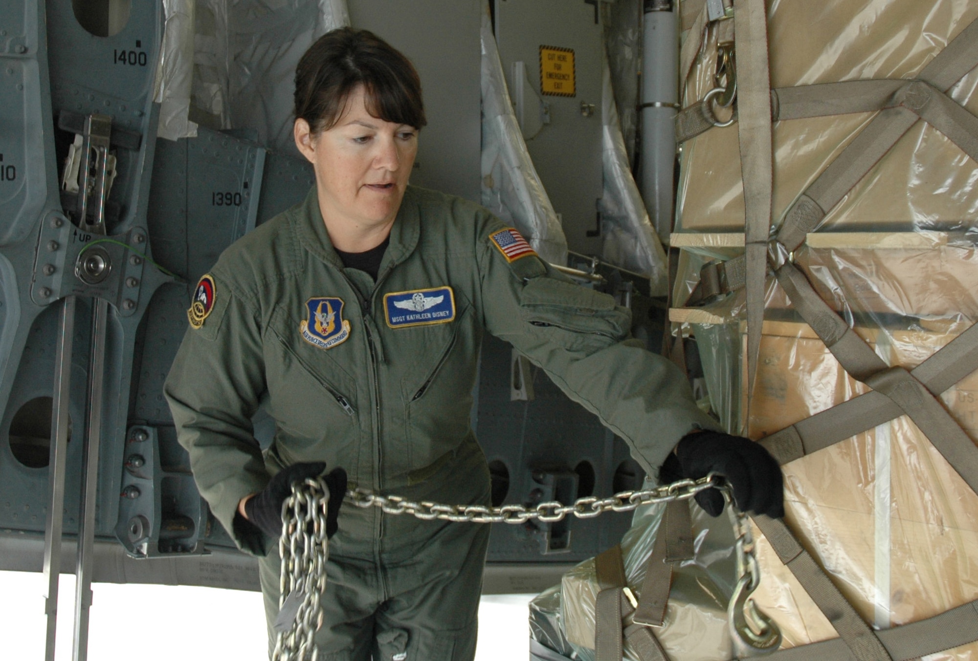 MCCHORD AIR FORCE BASE, Wash.- Master Sgt. Kathleen Disney, a loadmaster with the 313th Airlift Squadron here, chains up a pallet of goods that will be transported to Antarctica as part of Operation Deep Freeze, a humanitarian mission to transport good and equipment to the civilians at McMurdo Station, Antarctica. Sergeant Disney took a brief break from training future loadmaster instructors at the C-17A Instructor Loadmaster Course, Altus Air Force Base, Okla., in order to get her Deep Freeze Instructor certification . (U.S. Air Force photo/Tech. Sgt. Jake Chappelle)