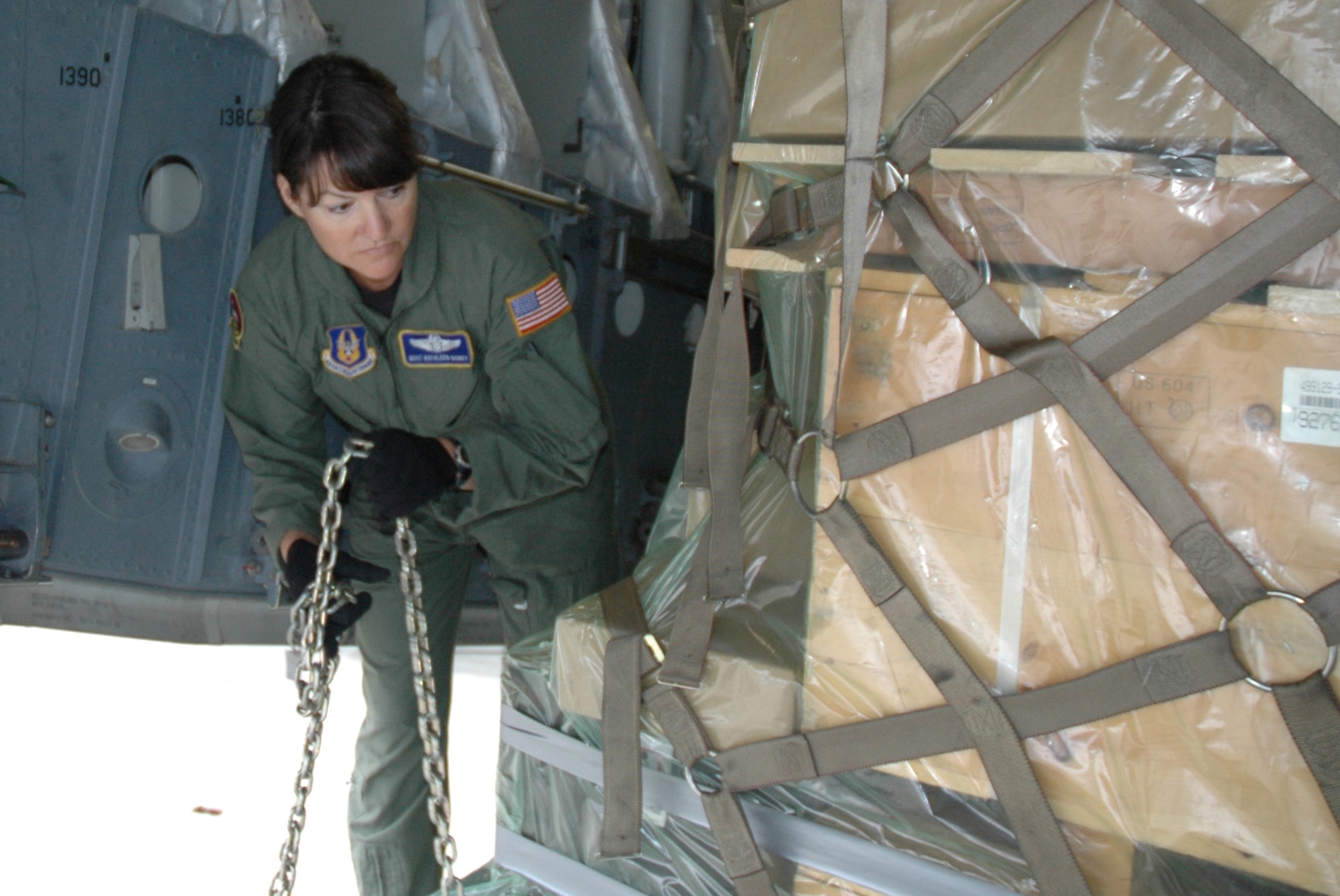 MCCHORD AIR FORCE BASE, Wash.- Master Sgt. Kathleen Disney, a loadmaster with the 313th Airlift Squadron here, chains up a pallet of goods to be transported to Antarctica as part of Operation Deep Freeze. Sergeant Disney was an instructor at the C17A Loadmaster Initial Qualification Course, Altus Air Force Base, Okla., last year and will teach there again when she returns from Deep Freeze. (U.S. Air Force photo/Tech. Sgt. Jake Chappelle)