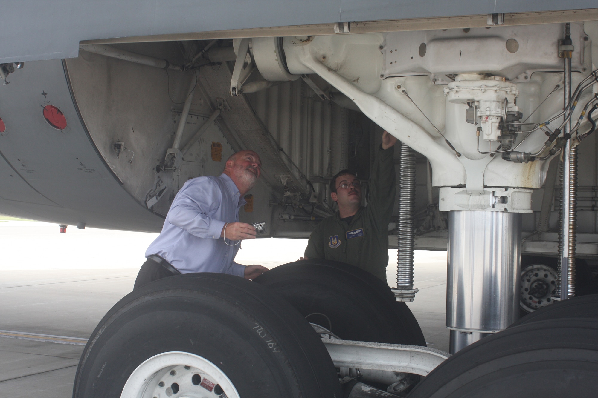 WRIGHT-PATTERSON AIR FORCE BASE, Ohio – Staff Sgt. Zachary Ditto, 89th Airlift Squadron, shows Tim Bannister, Essex Industries, Inc., the underside mechanics of a C-5 Galaxy.  Mr. Bannister and 23 civic leaders from the local area of Scott Air Force Base, Ill., and their military escorts from the 375th Airlift Wing and 932nd Airlift Wing, spent the day touring the 445th Airlift Wing and the National Museum of the United States Air Force Sept. 23. Col. Roger Gallet, 445th Operations Group commander and Col. Brad Spacy, 88th Air Base Wing commander, welcomed and provided wing mission briefings to the group. (U. S. Air Force photo/Stacy Vaughn)