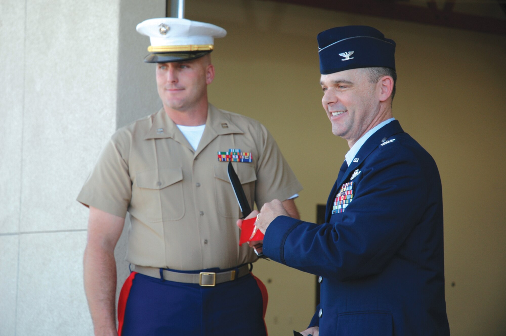 Marine Corps Capt. Nathan Bowlin and Col. Jeff Weed, 56th Fighter Wing vice commander, cut a ribbon Sept. 12 during a ceremony for the new home of the 6th Engineer Support Battalion Bulk Fuel Company Charlie. (U.S. Air Force photo/Senior Airman Andre Bowser)
