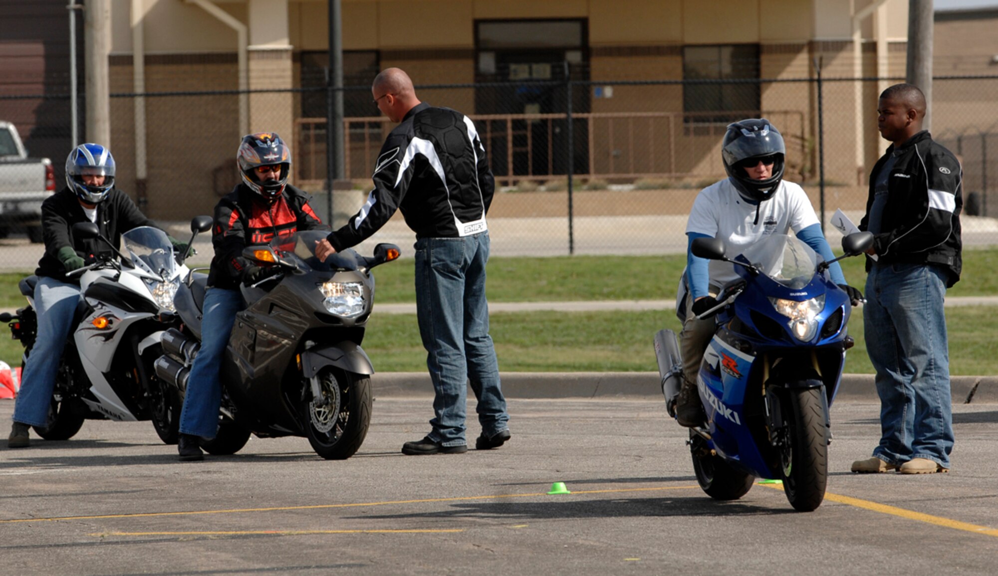 Sport bike safety instructors evaluate Airmen riding through a sport bike course, Sept. 18, 2009, in a parking-lot at McConnell Air Force Base, Kan. The course is designed to teach riders to properly negotiating turns, accelerate, use throttle control and brake their bikes.  (U.S. Air Force photo/Senior Airman Jessica Lockoski)