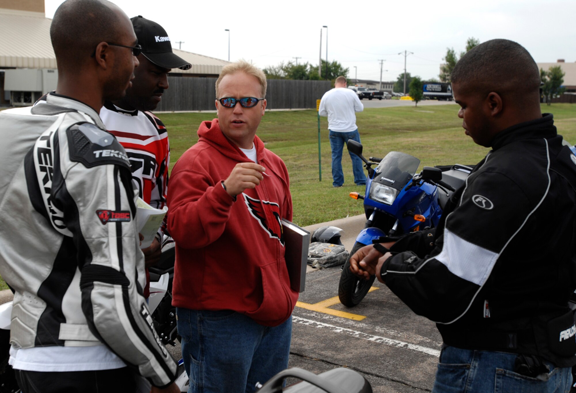 Tech. Sgt. Brian Evans, center, explains to Airmen certified to teach a sport bike course the key elements to look for when instructing students, Sept. 18, 2009, at McConnell Air Force Base, Kan.  Sergeant Evans, Air Mobility Command’s chief sport bike safety instructor, visited McConnell from the 60th Aircraft Maintenance Squadron, Travis AFB, Calif. and certified Airmen to instruct a sport bike specific course, now mandatory for active-duty riders in AMC. (U.S. Air Force photo/Senior Airman Jessica Lockoski)