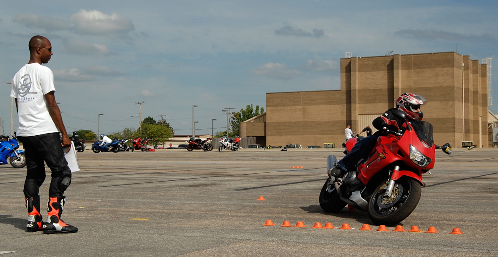 Capt. James Hodges, a sport bike safety instructor from the 22nd Aircraft Maintenance Squadron, evaluates a sport bike rider’s ability to make an “emergency” turn, Sept. 18, 2009, at McConnell Air Force Base, Kan.  The captain is among four volunteer Airmen recently certified to instruct the sport bike course here. (U.S. Air Force photo/Senior Airman Jessica Lockoski)