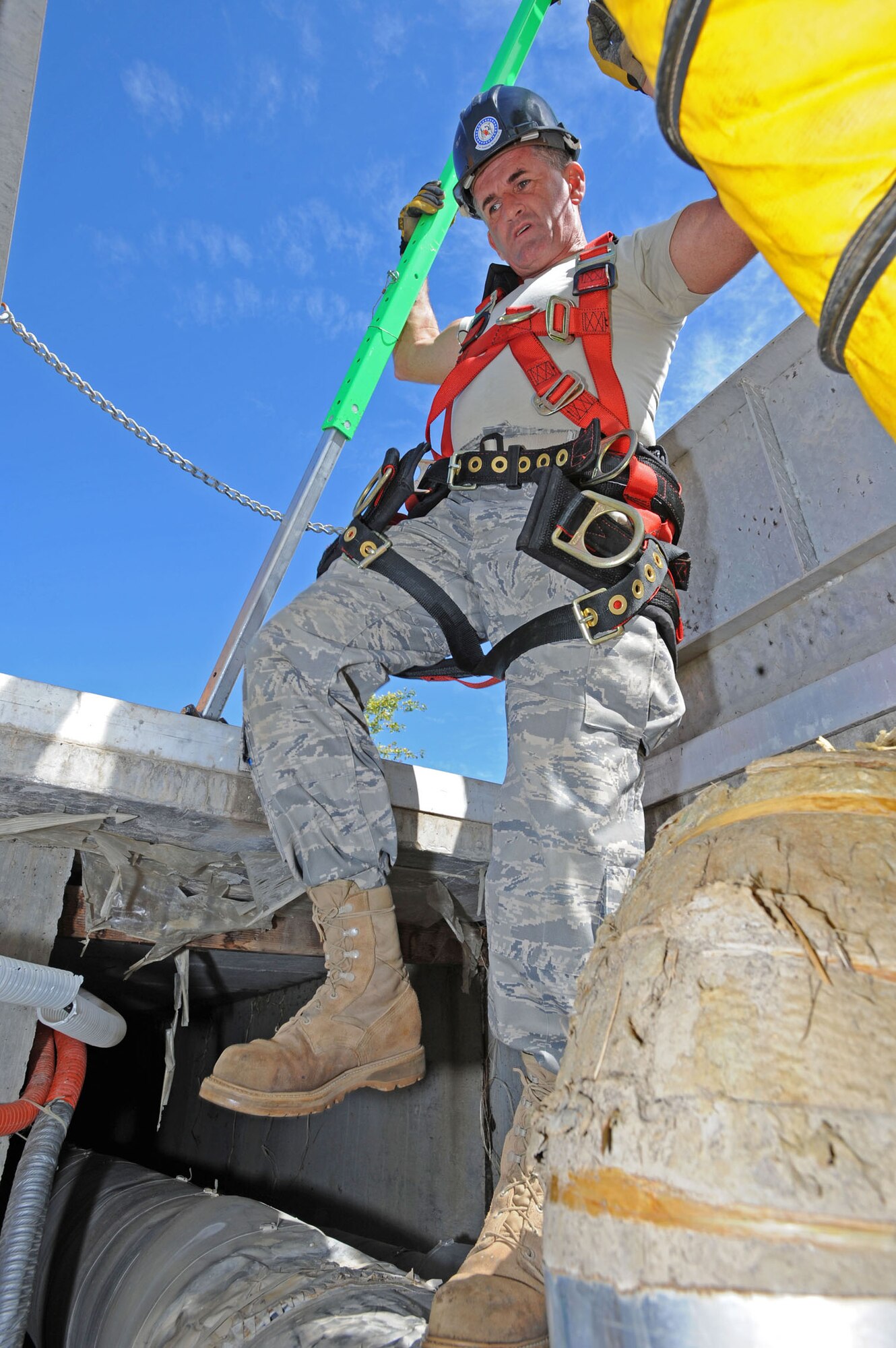WHITEMAN AIR FORCE BASE, Mo. - Staff Sgt. Darreyl Walker, 217th Engineering Installation Squadron cable systems technician, climbs down into a maintenance tunnel, Sept. 24. Air National Guard members from both the 271st and the 241st have spent more than two months at Whiteman AFB replacing copper transmission cable with more efficient fiber optic cable. The fiber optic cable will provide 50 percent more capability and expansion to utilize a greater number of networked products. (U.S. Air Force photo/Airman 1st Class Carlin Leslie)