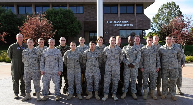 Col. Jay Raymond, 21st Space Wing commander (left), awarded the 21st Security Forces Squadron Delta Flight the Golden Knight Award for March, for providing unsurpassed installation protection, law enforcement and security for Peterson. (Air Force photo by Craig Denton)