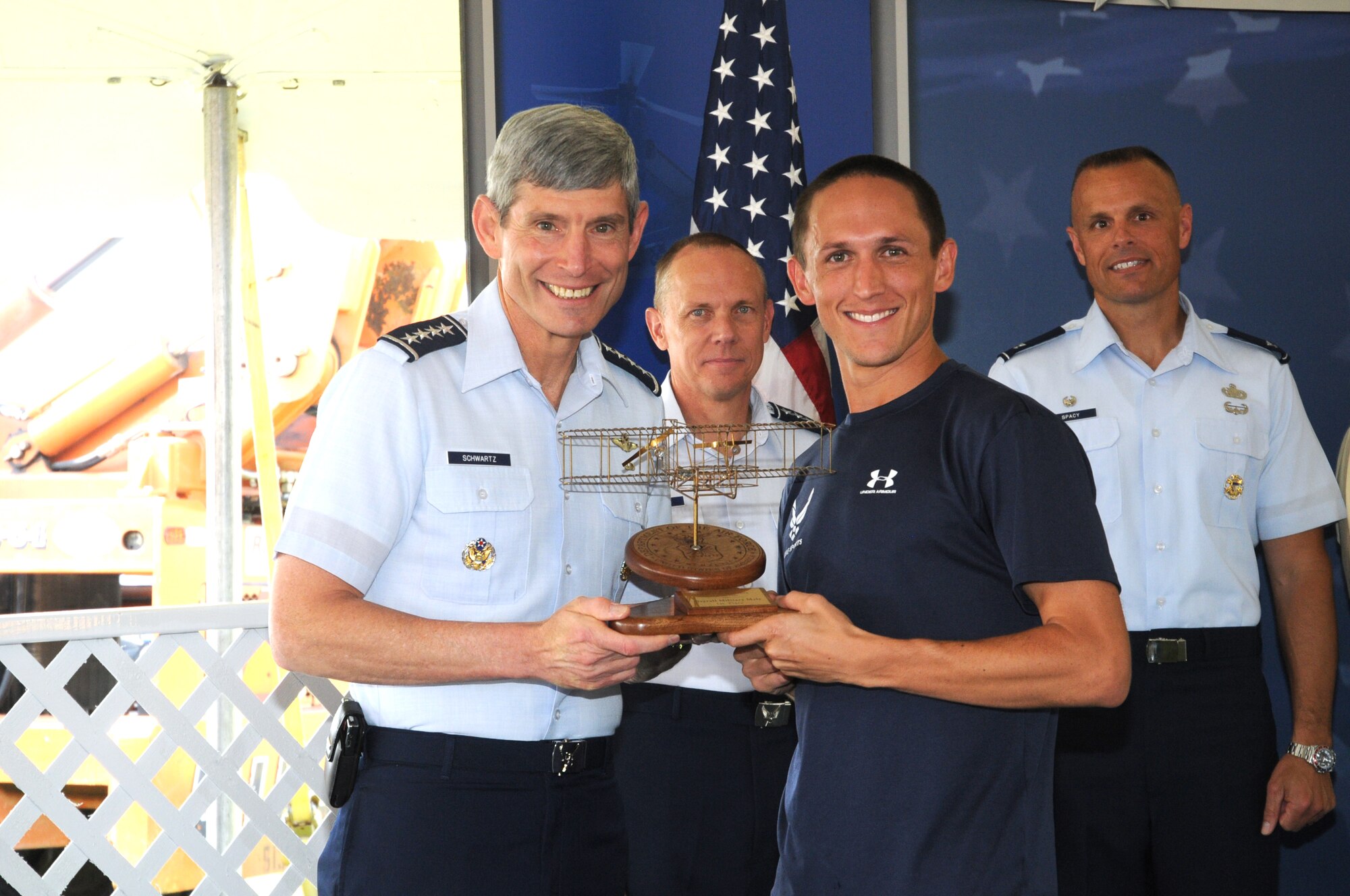 Air Force Chief of Staff Gen. Norton Schwartz presents a trophy to Capt. Ben Payne, top Air Force finisher for the men's half marathon, Sept. 19, 2009 at Wright-Patterson Air Force Base, Ohio. Payne finished second overall in the half marathon, clocking in at 1:08:58.  Capt. Payne is a T-6 instructor pilot with the 41st Flying Training Squadron, Columbus AFB, Miss. (Air Force photo/Al Bright)
