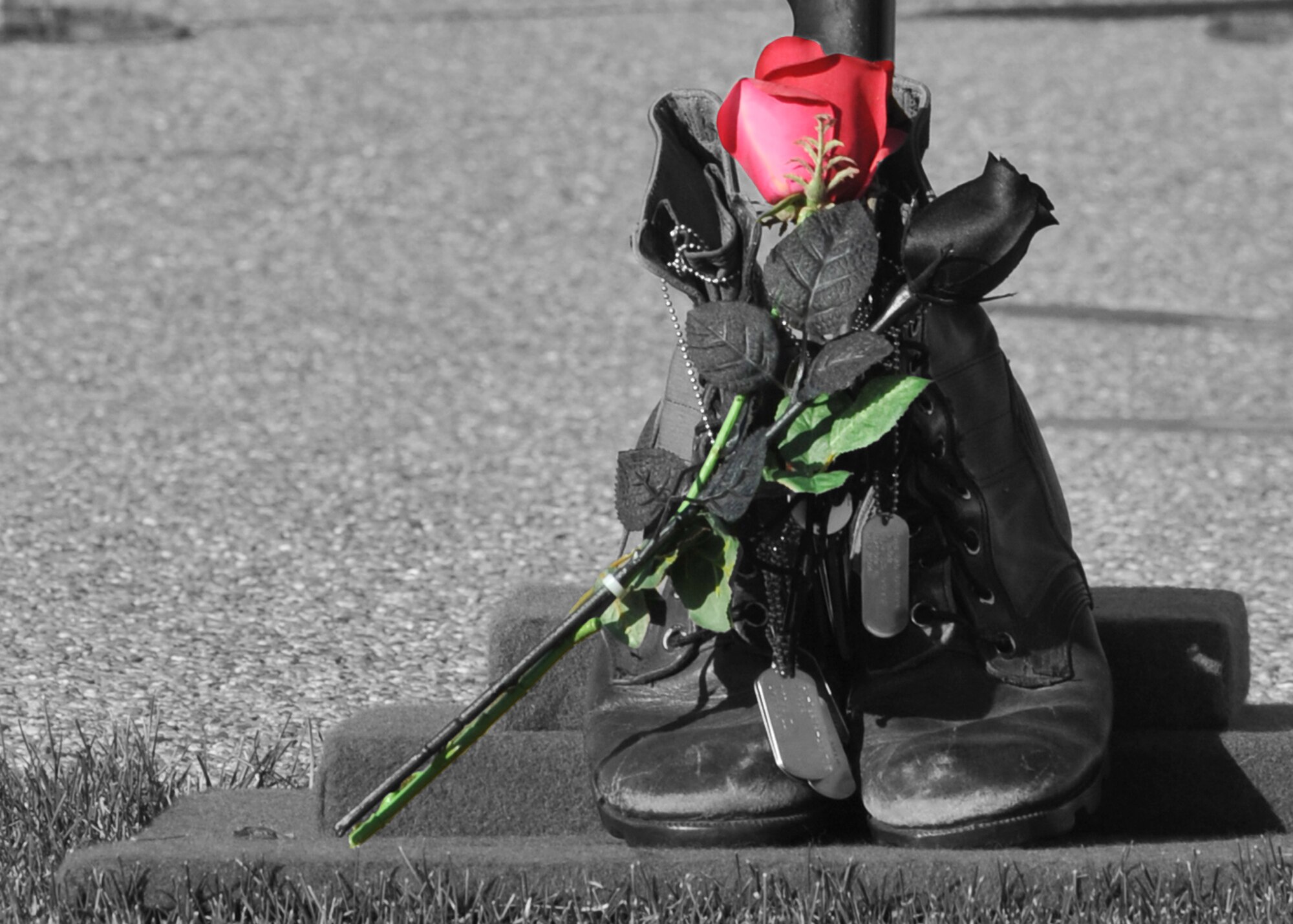ELMENDORF AIR FORCE BASE, Alaska -- A pair of worn boots holds a set of dogtags and a red and a black rose as a tribute to fallen soldiers during the POW/MIA Memorial Sept. 18, 2009. The ceremony honored our prisoners of war and those still missing in action. (U.S. Air Force photo illustration/Senior Airman Laura Turner)