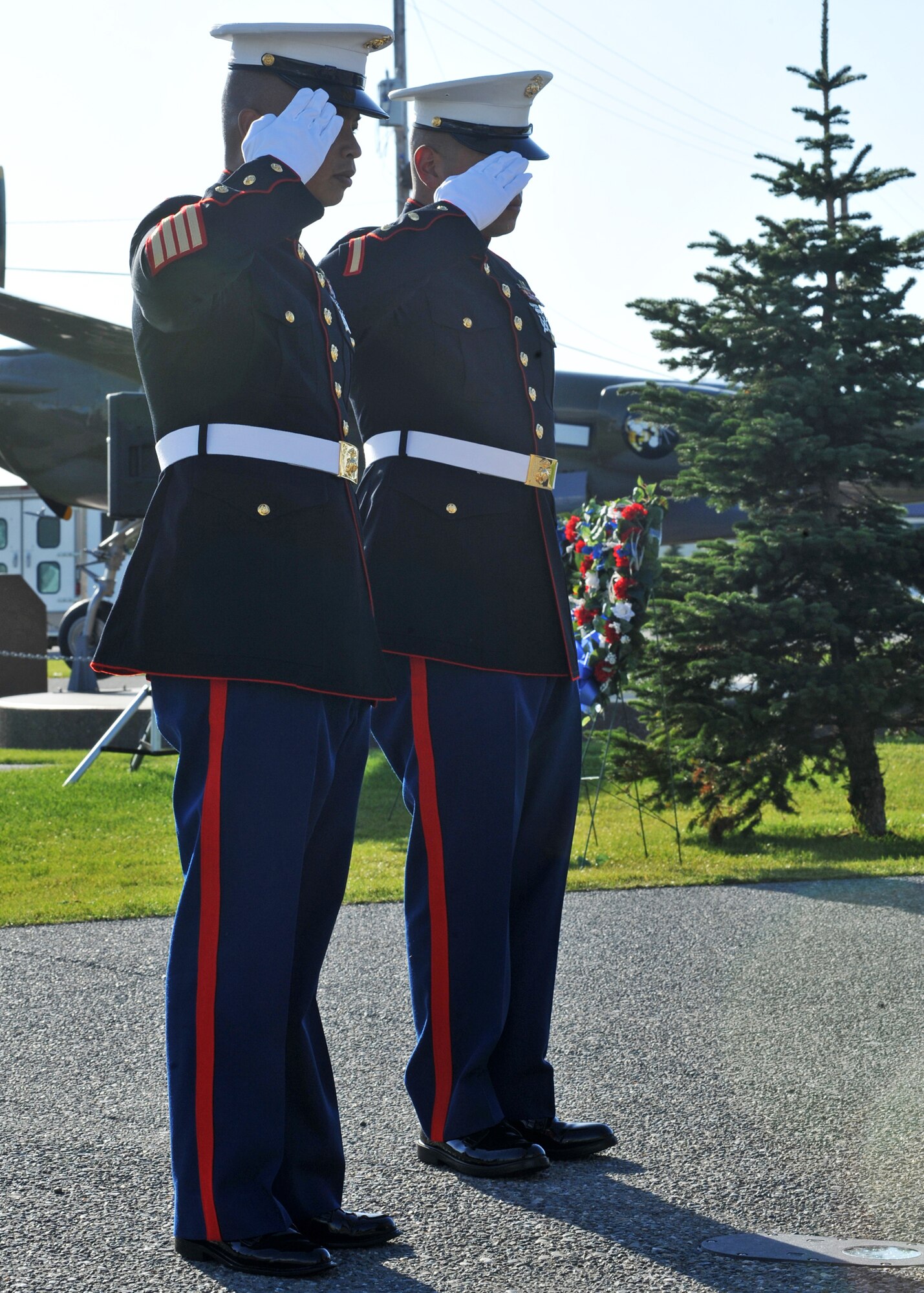 ELMENDORF AIR FORCE BASE, Alaska -- Marine Corps 1st Sgt. Marvin Magcale and Sgt. Nicholas Garcia salute a ceremonial wreath at the POW/MIA Memorial Sept. 18, 2009. Members of each branch placed a wreath during the memorial in honor of our prisoners of war and those still missing in action. (U.S. Air Force photo/Senior Airman Laura Turner)