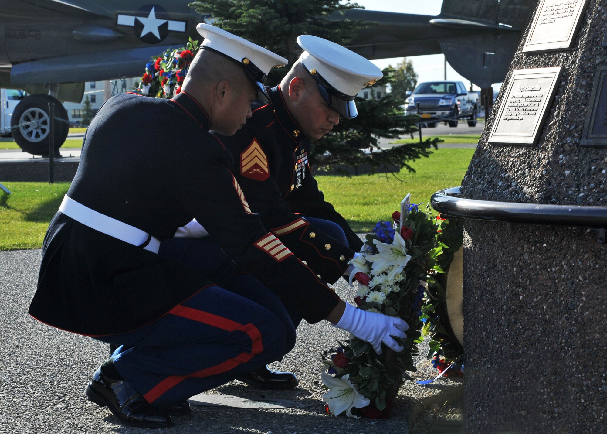 ELMENDORF AIR FORCE BASE, Alaska -- Marine Corps 1st Sgt. Marvin Magcale and Sgt. Nicholas Garcia place a ceremonial wreath at the POW/MIA Memorial Sept. 18, 2009. Members of each branch placed a wreath during the memorial in honor of our prisoners of war and those still missing in action. (U.S. Air Force photo/Senior Airman Laura Turner)