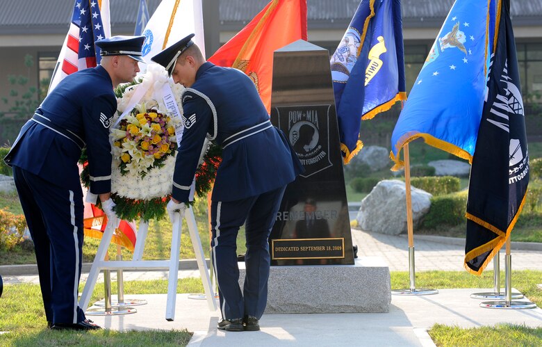 Osan Air Base honor guard Airmen lay a wreath in front of a POW/MIA remembrance statue during a dedication ceremony in front of the base theater Sept. 18, 2009, at Osan Air Base, South Korea. (U.S. Air Force photo/Staff Sgt. Brian Ferguson)