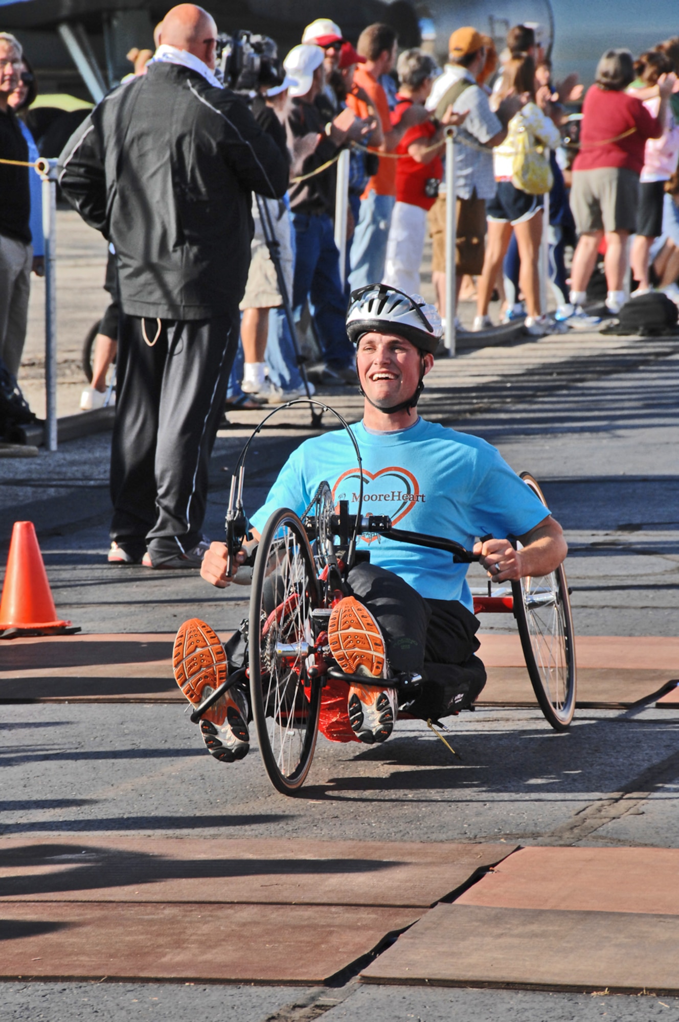 John Moore of Centerville, Ohio, crosses the finish line after completing the U.S. Air Force Marathon Sept. 19, 2009 at Wright-Patterson Air Force Base, Ohio. Moore was paralyzed from the waist down in Septermber 2008 during an accident following the passage of Hurricane Ike. He remains a firefighter with the city of Kettering, where he supports educational outreach. He finished the 26.2 miles averaging just over 5 minutes per mile. His wife Meredyth ran the half marathon. (Air Force photo/Ben Strasser)