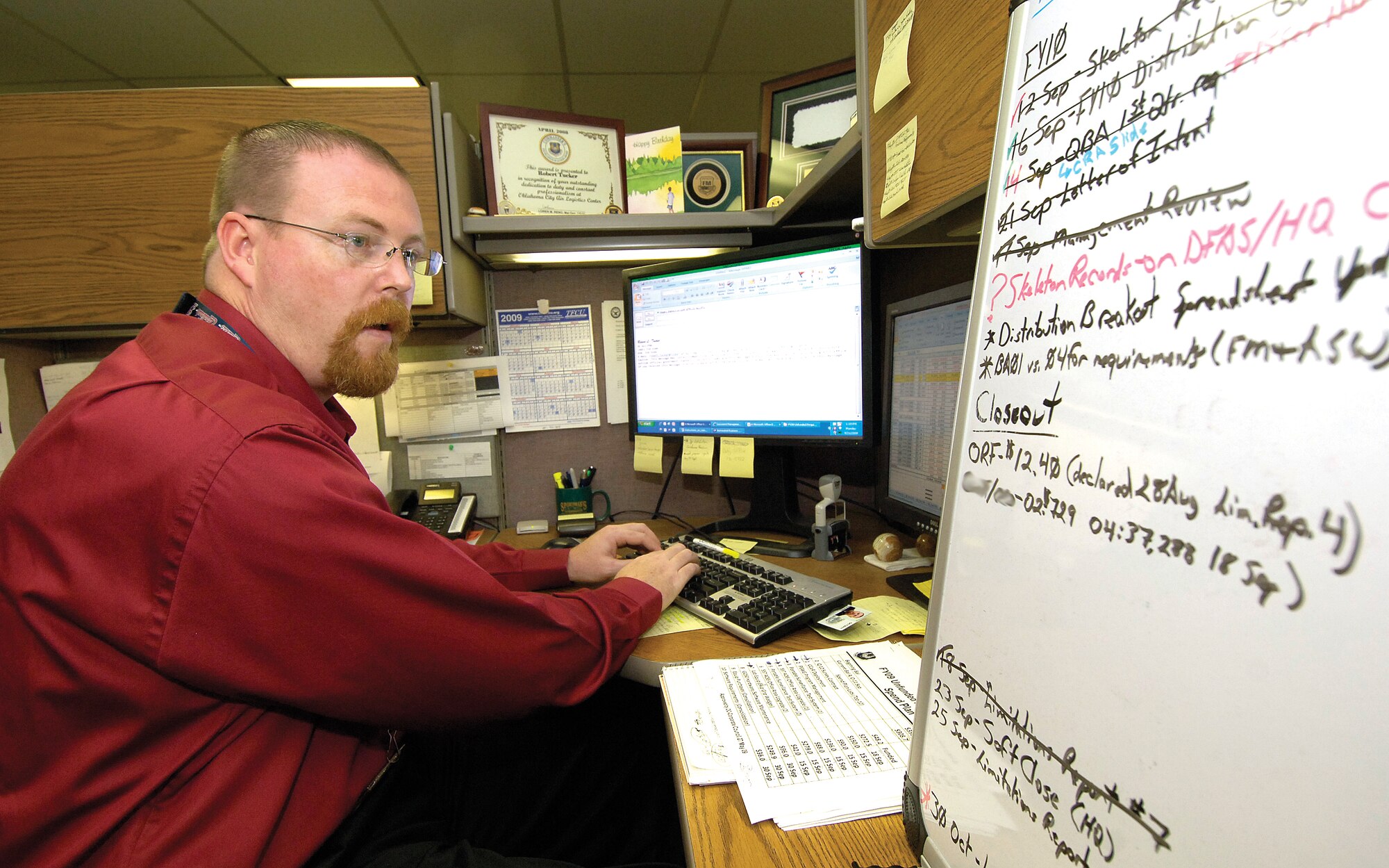 Rob Tucker, budget analyst with the Oklahoma City Air Logistics Center Financial Management Directorate, works through his fifth fiscal-year close out. He has a board set up for the tasks he needs to complete before the fiscal year closes Sept. 30. (Air Force photo by Margo Wright)