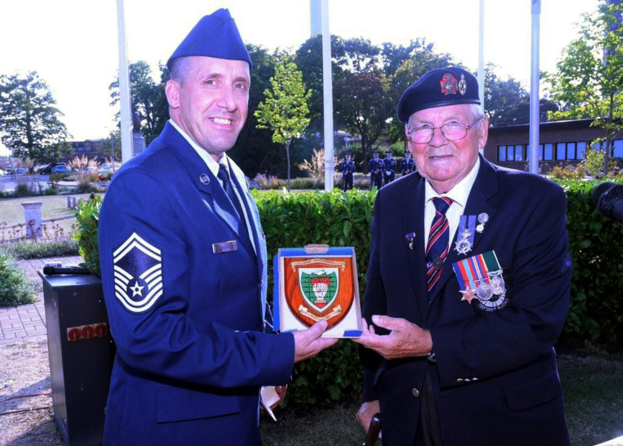 Senior Master Sgt. Daniel Janssen, 48th Logistics Readiness Squadron fuels management flight chief,  receives a plaque from the Ex-Prisoners of War Association presented by Les Allen, a former POW, during the POW/MIA Week retreat ceremony Sept. 18, 2009, at Memorial Park on RAF Lakenheath, England. Mr. Allen was the guest speaker at the retreat ceremony. (U.S. Air Force photo/Airman 1st Class Eboni Knox)