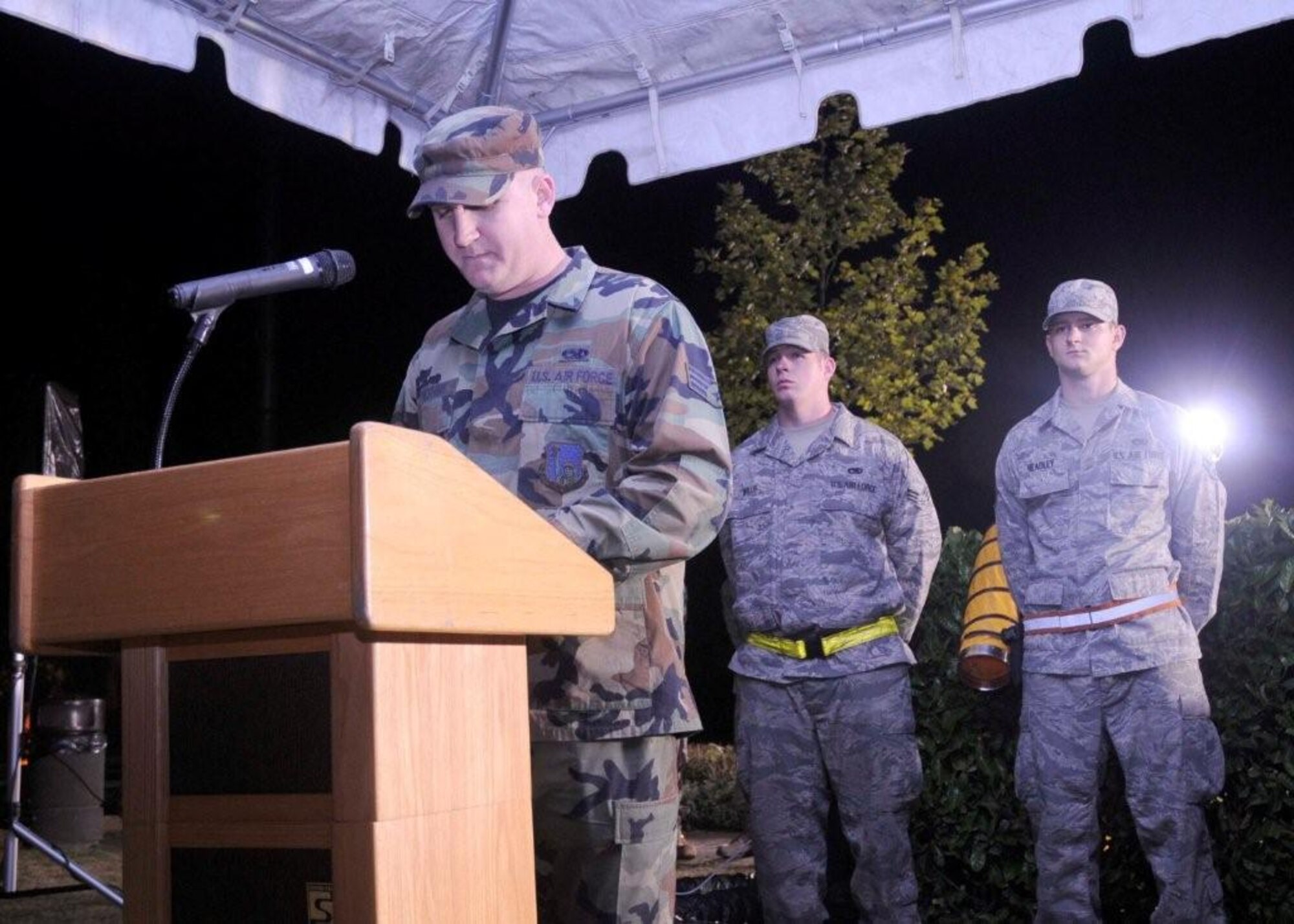 Senior Airman Joseph Chesire, 48th Equipment Maintenance Squadron crash recovery journeyman, reads the names of POW/MIA personnel in the early morning hours, Sept. 18, 2009, at RAF Lakenheath, England. Airmen read the names for 24 hours to remember those who have not returned or been accounted for. (U.S. Air Force photo/ Airman 1st Class Eboni Knox)