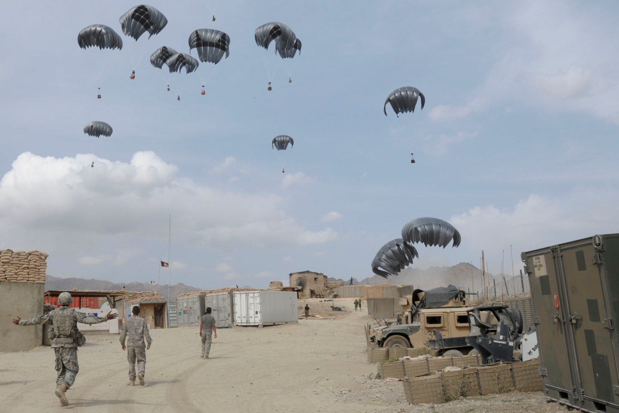 U.S. Army Soldiers prepare to gather fuel supplies being dropped from a C-130 Hercules aircraft onto a landing zone at Forward Operating Base Baylough in the Zabul province of Afghanistan on Sept. 17, 2009. The Soldiers are assigned to Alpha Company, 1st Battalion, 4th Infantry Regiment. (U.S. Army Photo/Spc. Tia P. Sokimson) 