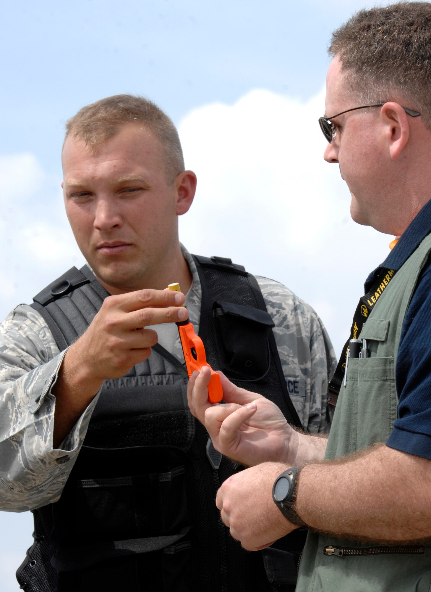 Tech. Sgt. Mark Hellwig, left, and Master Sgt. David Parker, 22nd Air Refueling Wing Safety, demonstrate how to load a single-shot, pyro-launcher, Sept. 16, 2009, during Bird Aviation Strike Hazard training at McConnell Air Force Base, Kan. The sergeants taught flight safety representatives BASH program methods to control bird populations around the base airfield. (U.S. Air Force photo/Senior Airman Laura Suttles) 