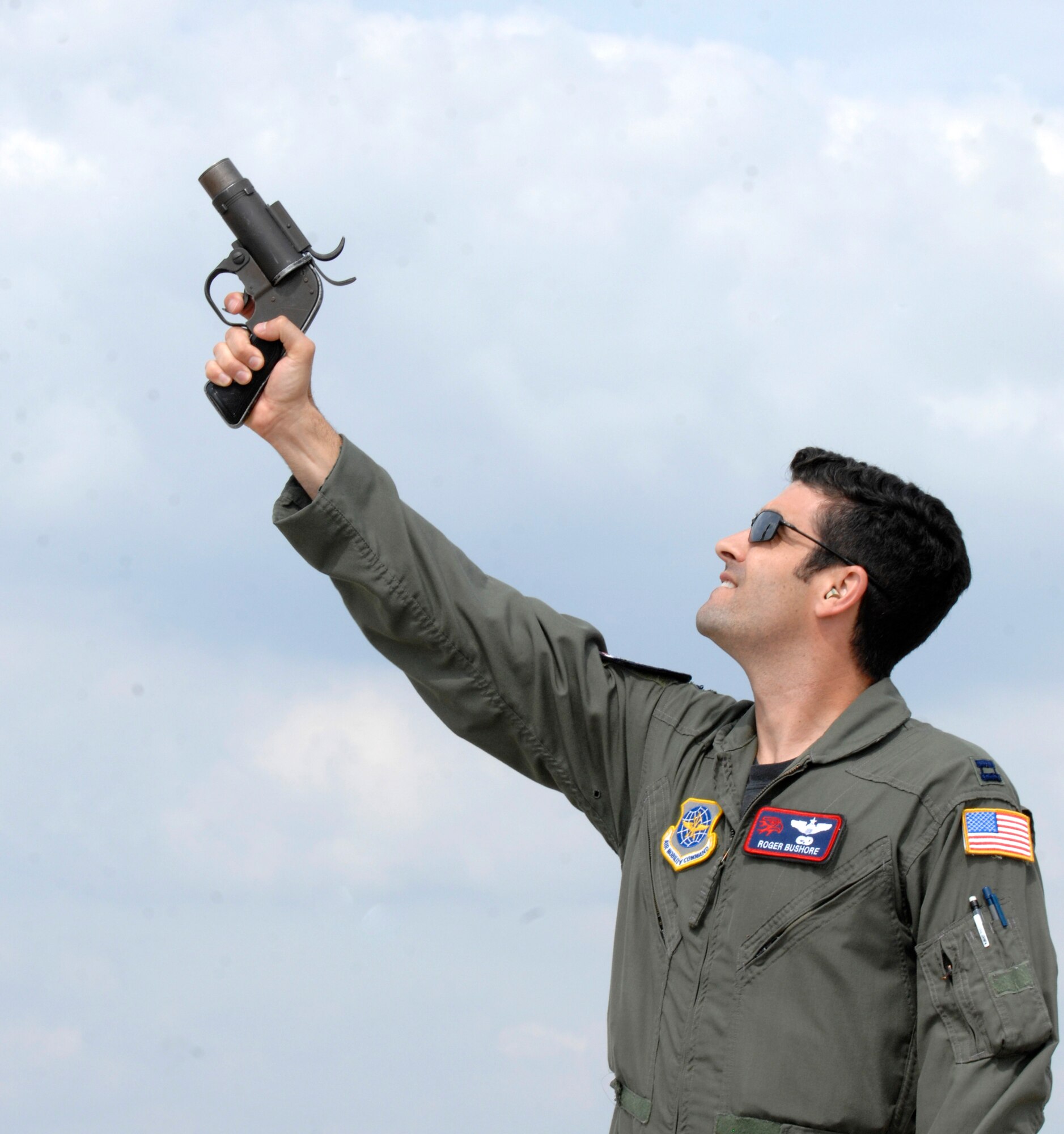 Capt. Roger Bushore, 350th Air Refueling Squadron unit safety representative, fires a flare gun, Sept. 16, 2009, during Bird Aviation Strike Hazard training at McConnell Air Force Base, Kan. Airmen fired the gun near large flocks of birds to frighten them away from McConnell’s airspace. (U.S. Air Force photo/Senior Airman Laura Suttles)