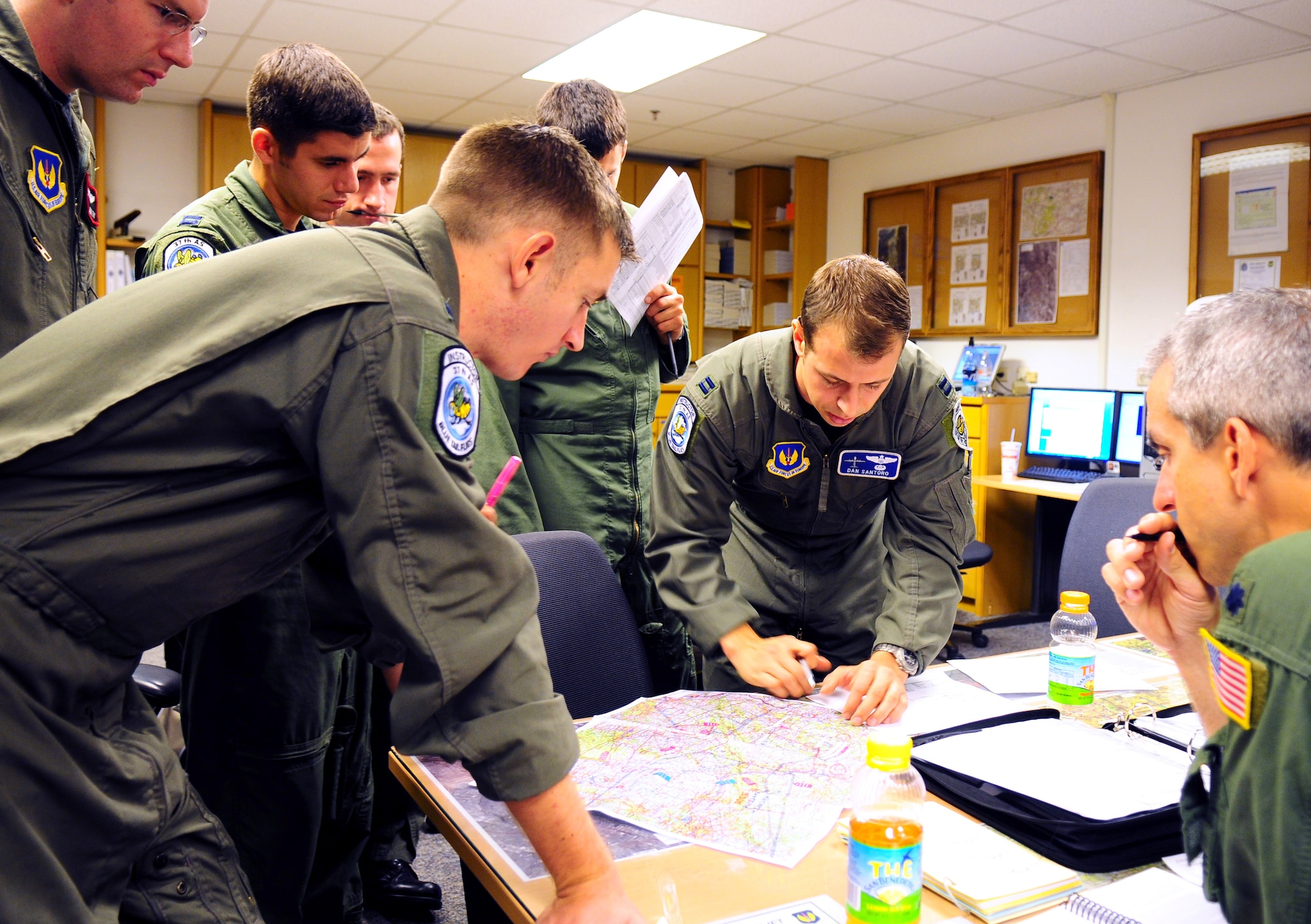 U.S. Air Force Capt Dan Santoro, a C-130 pilot with the 37th Airlift Squadron, goes over a map during the preflight briefing with other pilots that are scheduled to fly a local mission involving two C-130J models and one C-130E model from Ramstein AB, Germany on Sept 23, 2009. (U.S. Air Force photo by Staff Sgt. Jocelyn Rich)