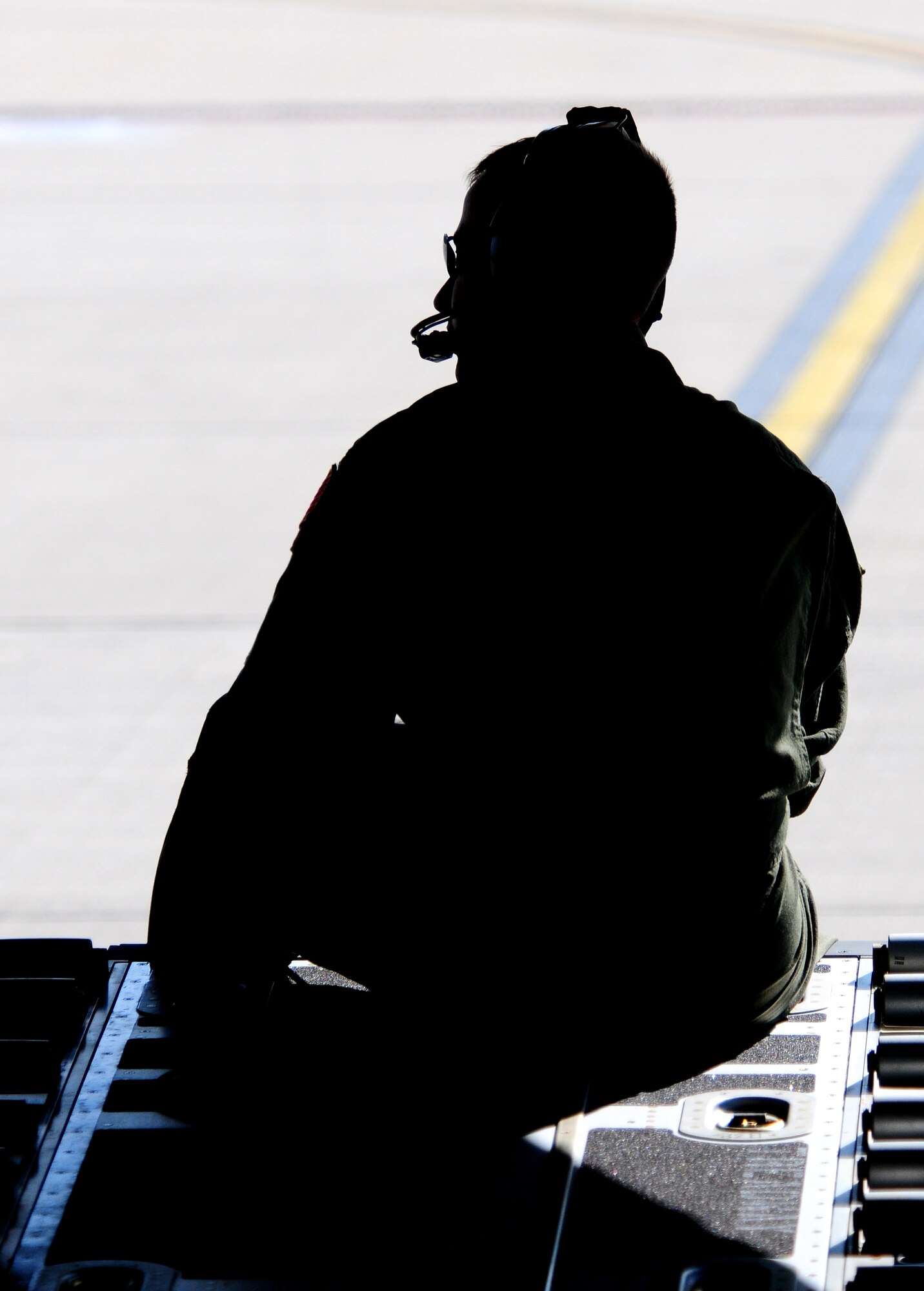 U.S. Air Force Staff Sgt. Francesco "Ace" Ventura, a load master/evaluator, with the 37th Airlift Squadron sits on a C-130J ramp as the crew prepares to take off for a flight from Ramstein AB, Germany on Sept 23, 2009. (U.S. Staff Sgt. Jocelyn Rich) 