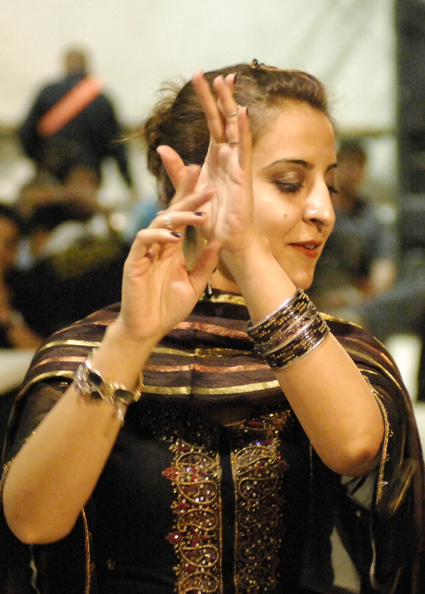 BAGRAM AIRFIELD, Afghanistan -- A local Afghan woman dances while an Afghan band plays during a celebration of Eid ul-Fitr, the Muslim feast that marks the end of fasting for Ramadan here, Sept. 22, 2009.  Ramadan is the Islamic month of fasting, in which participating Muslims refrain from eating, drinking, smoking, and indulging in anything that is in excess or ill-natured from dawn until sunset to concentrate on praying and the Qur'an.  (U.S. Air Force photo/Senior Airman Felicia Juenke)