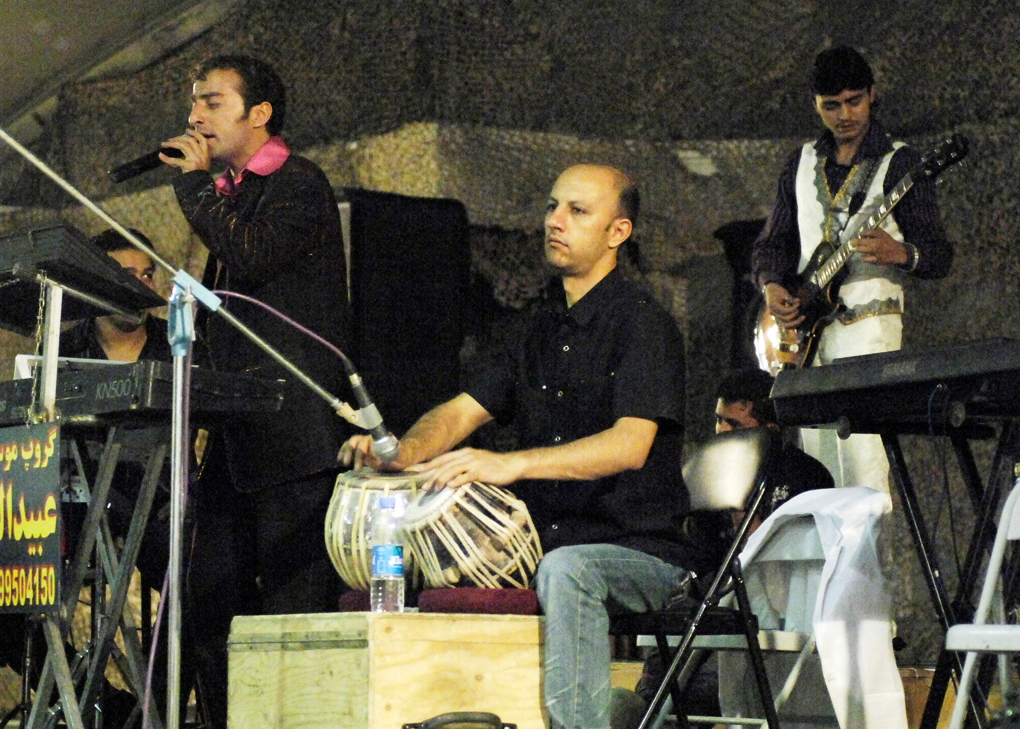 BAGRAM AIRFIELD, Afghanistan -- A local band entertains Airmen, Soldiers, Sailors, Marines and civilian guests gather for a celebration of Eid ul-Fitr, the Muslim feast that marks the end of fasting for Ramadan here, Sept. 22, 2009.  Ramadan is the ninth month of the Islamic calendar.  It is when the Muslims believe the Qur'an was sent down from the heavens.  Ramadan is the Islamic month of fasting, in which participating Muslims refrain from eating, drinking, smoking and indulging in anything that is in excess or ill-natured; from dawn until sunset to concentrate on praying and the Qur'an.  (U.S. Air Force photo/Senior Airman Felicia Juenke)