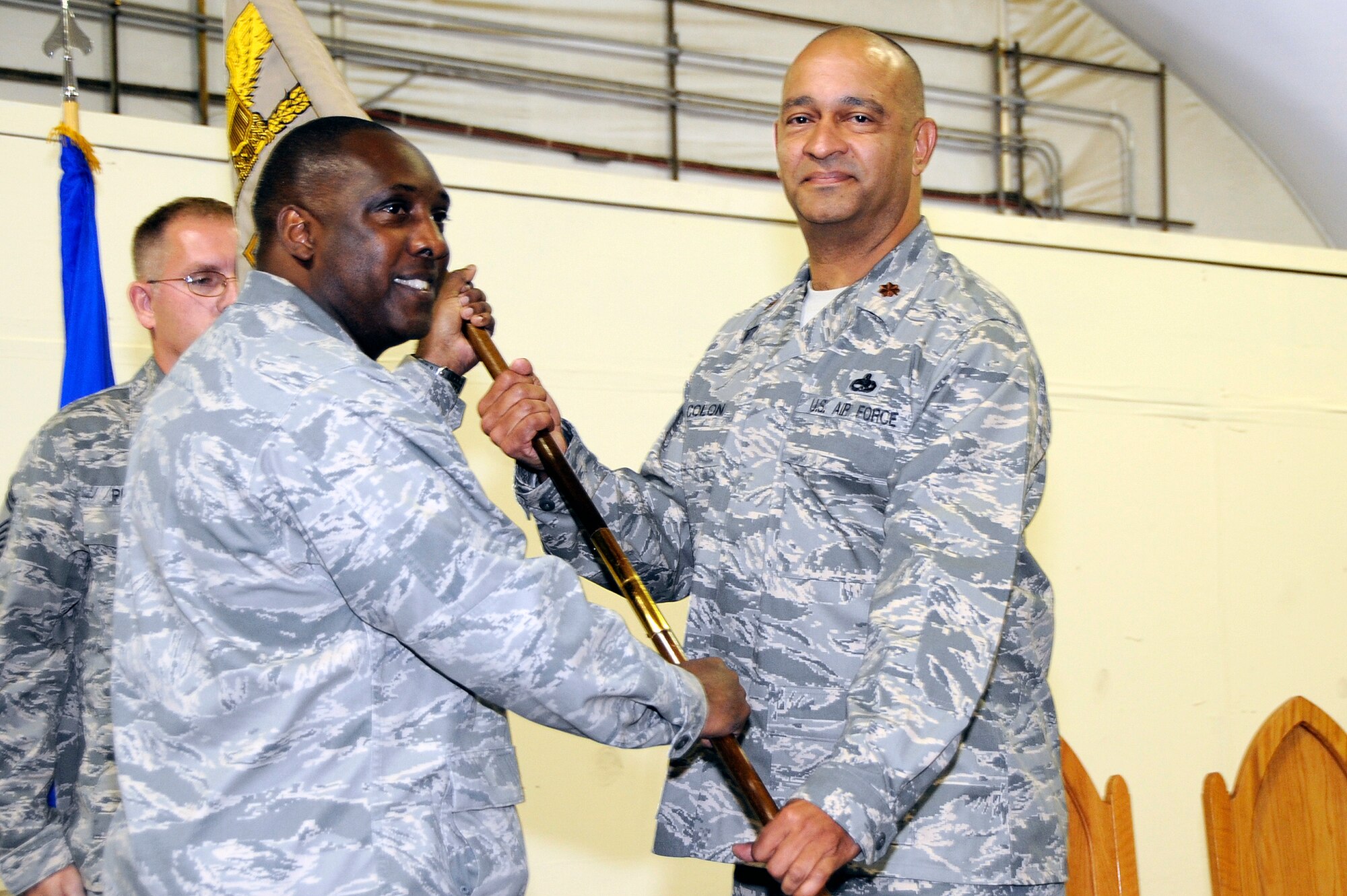 SOUTHWEST ASIA -Maj. Fernando Colon Jr., 380th Expeditionary Maintenance Squadron, receives the guidon from Col. Ricky Murphy, 380th Expeditionary Maintenance Group commander, during his assumption-of-command ceremony here Sept. 20, 2009. (U.S. Air Force photo/Tech. Sgt. Charles Larkin Sr)