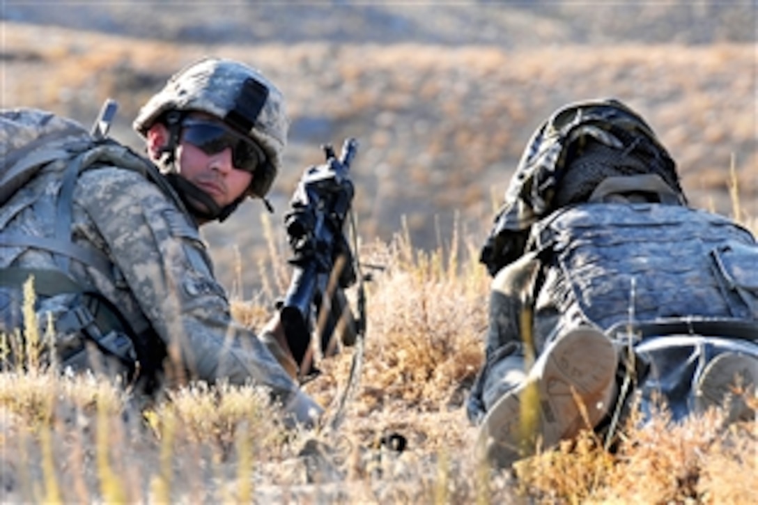 U.S. Army Pvt. Matthew Benzing, right, and Pvt. 1st Class Joshua Rouse, left, conduct a security over watch during a reconnaissance patrol near Forward Operating Base Mizan in Zabul province, Afghanistan, Sept. 12, 2009. Benzing and Rouse are assigned to Company A, 1st Battalion, 4th Infantry Regiment.