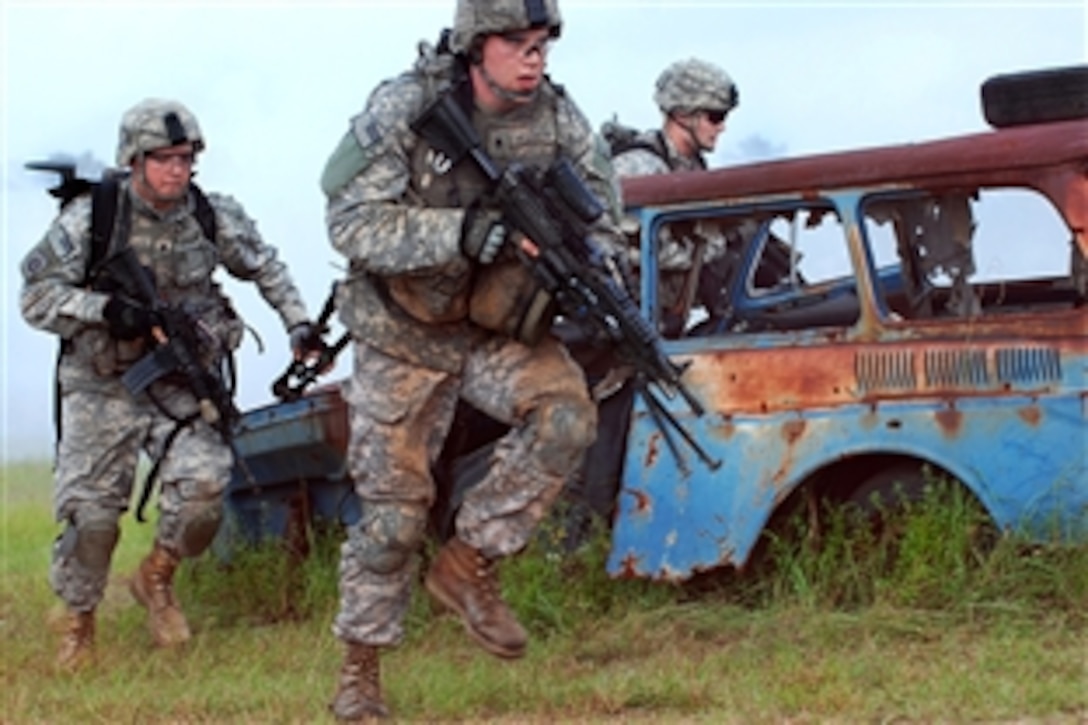 U.S. Army paratroopers rush out from behind cover while assaulting an objective during combined arms live fire training on Fort Bragg, N.C., Sept. 17, 2009. The soldiers are assigned to the  82nd Airborne Division's Company B, 2nd Battalion, 325th Airborne Infantry Regiment, 2nd Brigade Combat Team.