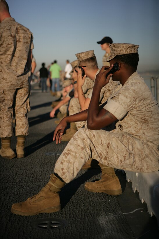 Marines on the flight deck of USS Bonhomme Richard make phone calls moments before deploying with the 11th Marine Expeditionary Unit Sept. 24.